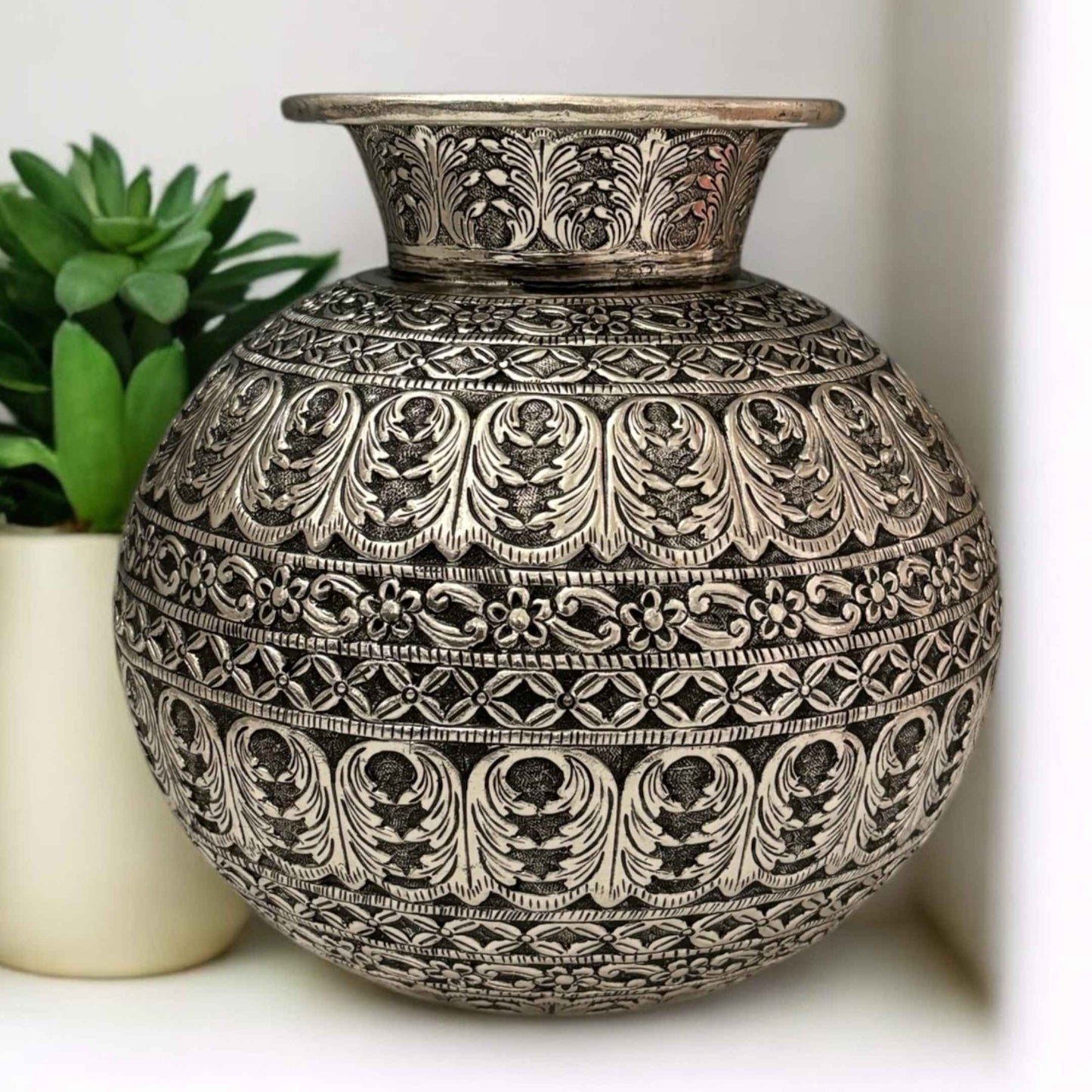 Front view of antique silver Matka vase with intricate engravings