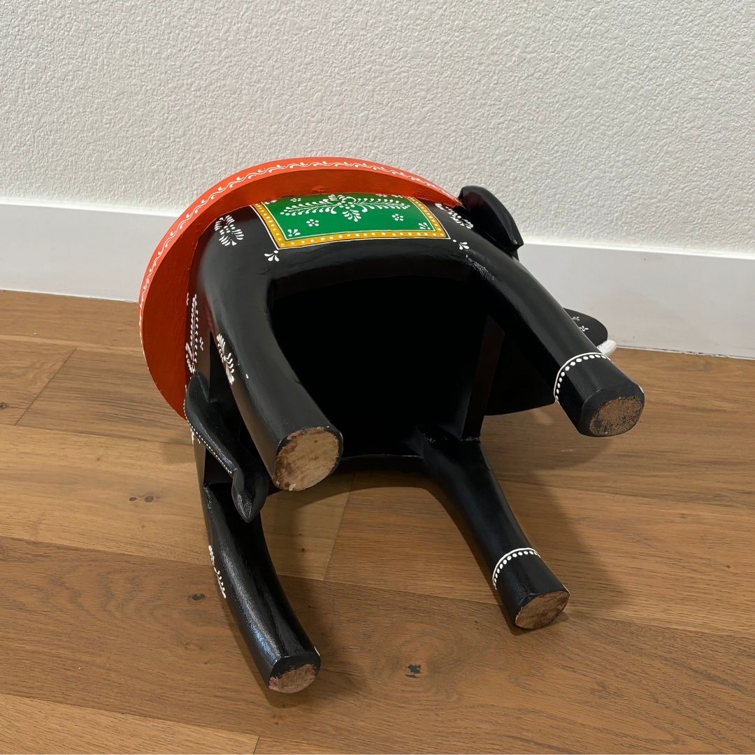 Side view of the black elephant stool showcasing sturdy construction and ornate details