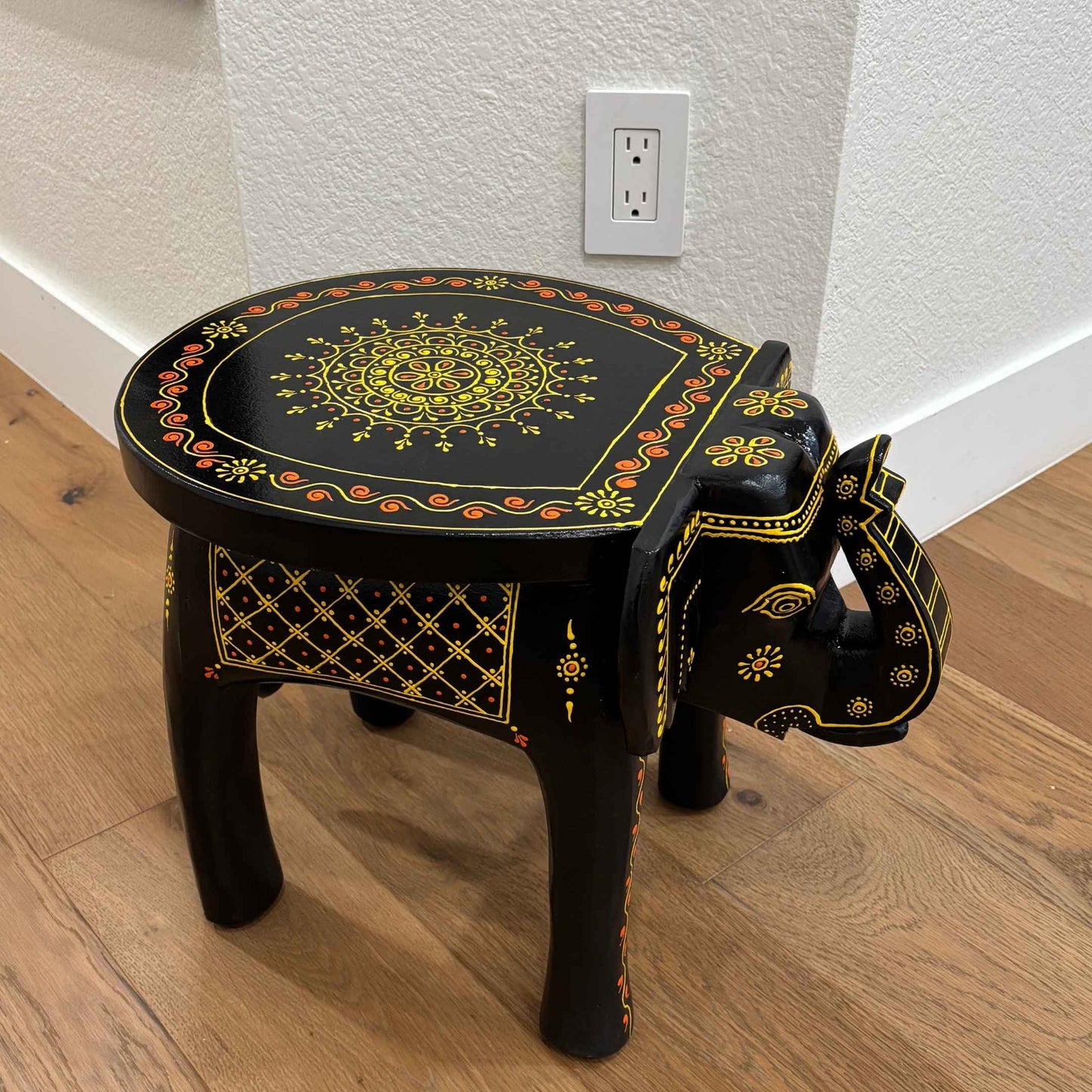 Top view of the wooden elephant stool showcasing its smooth round tabletop and natural finish