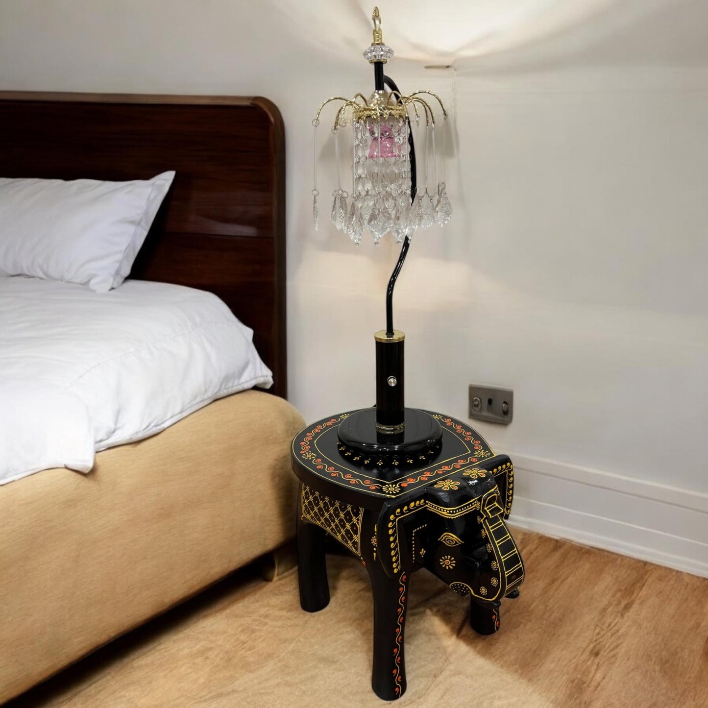 Wooden elephant stool styled as a table lamp in a cozy bedroom room with modern decor
