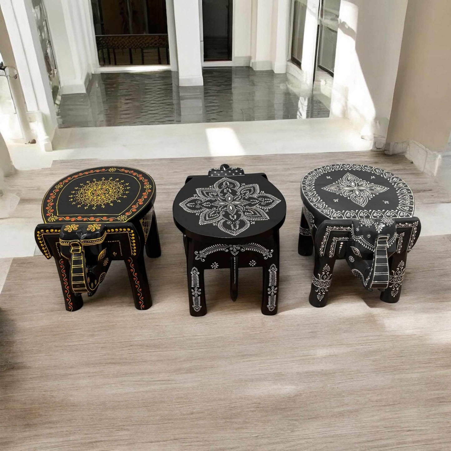 Detailed carvings on the black elephant stool with a smooth and elegant black finish