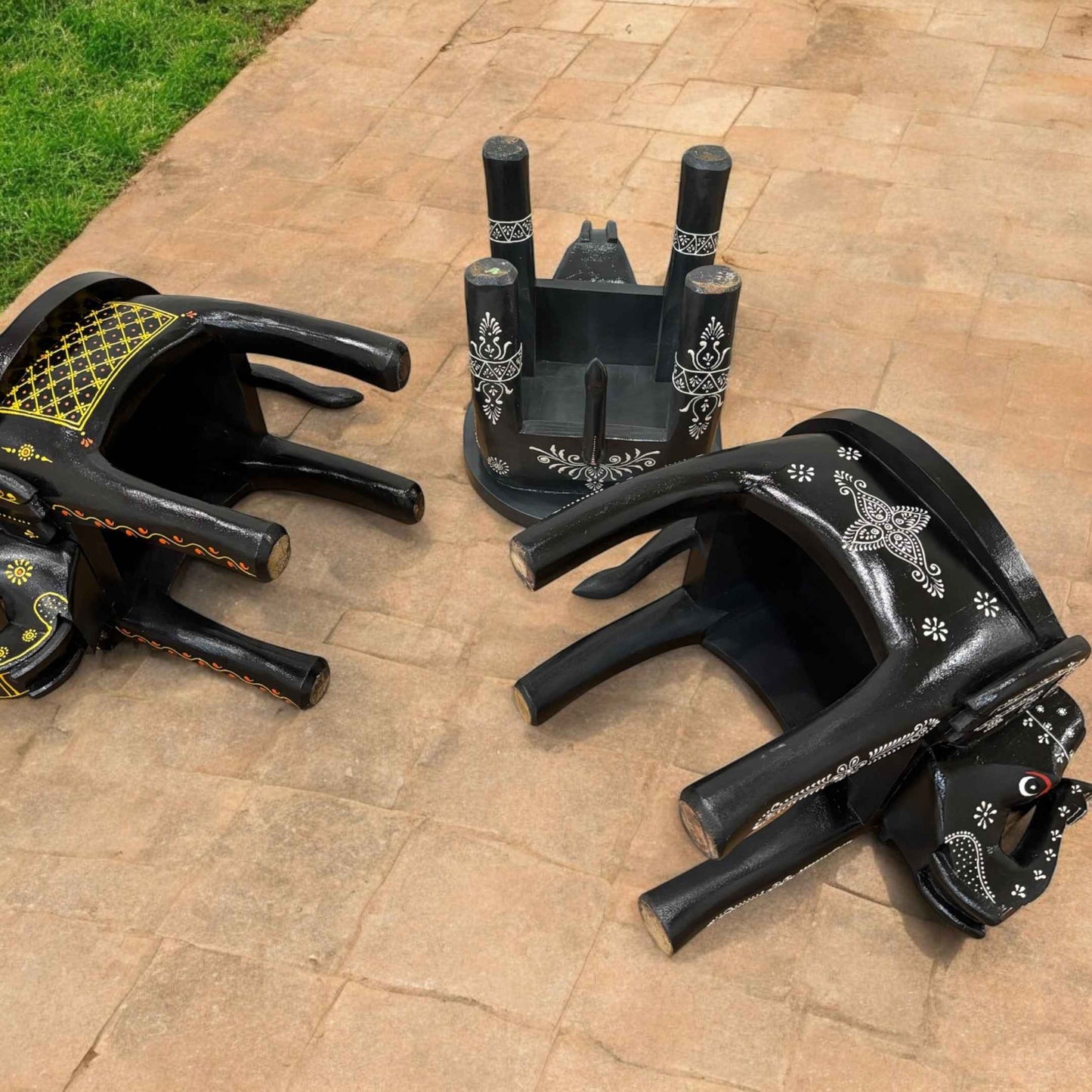 Side view of the black elephant stool showcasing sturdy construction and ornate details