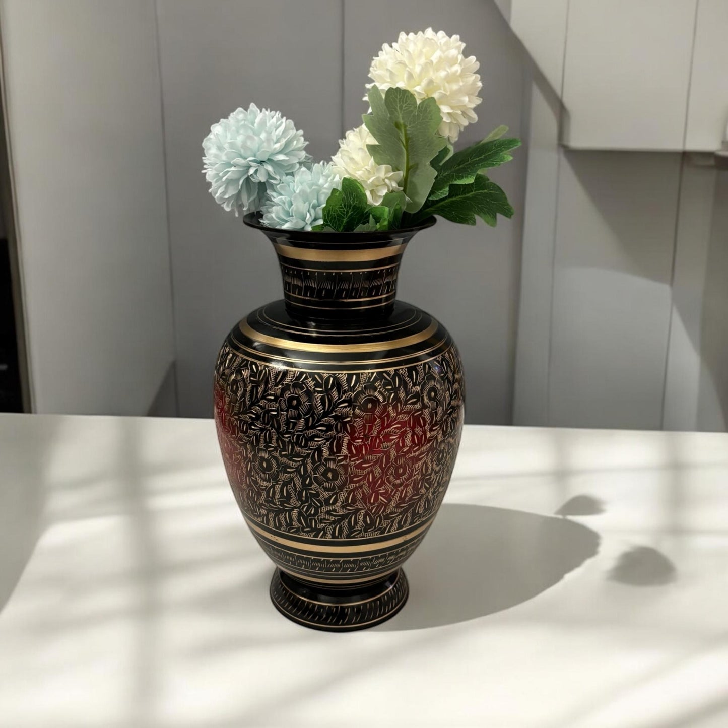 Handmade 11-inch tall brass vase with fine engraved floral etching in black finish, perfect for home decor