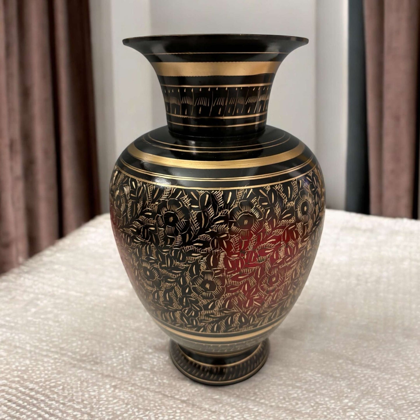 Brass vase placed on a wooden table, enhancing home decor with vintage charm