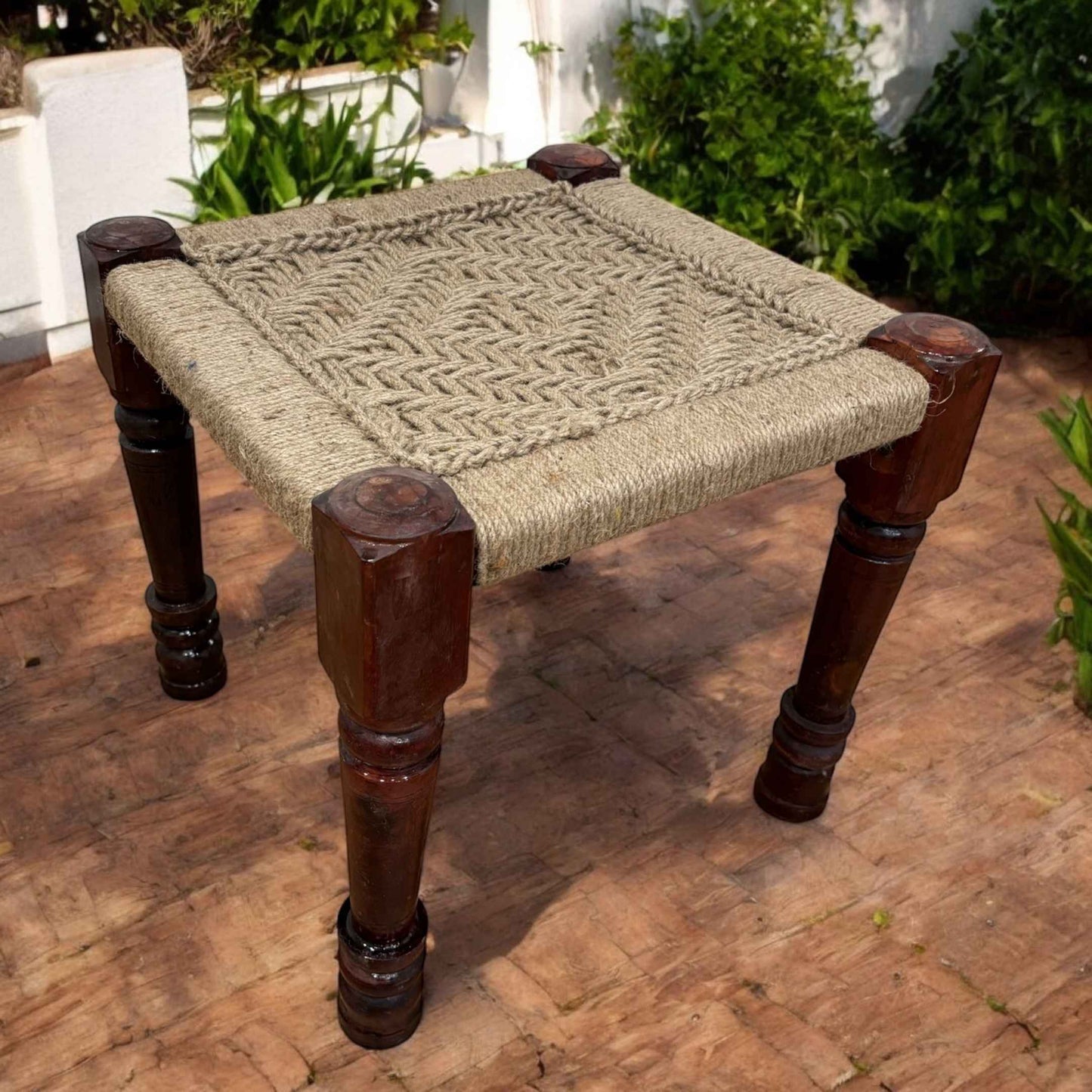 Handcrafted Charpai stool with intricately woven jute cord top, showcasing a clean and organic aesthetic.