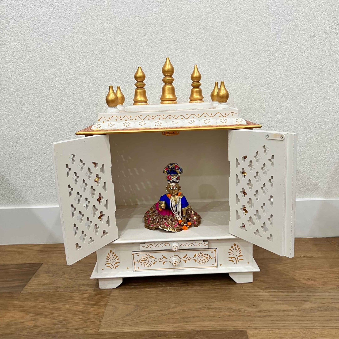 White and Gold Wooden Pooja Mandir showing god statue for worship