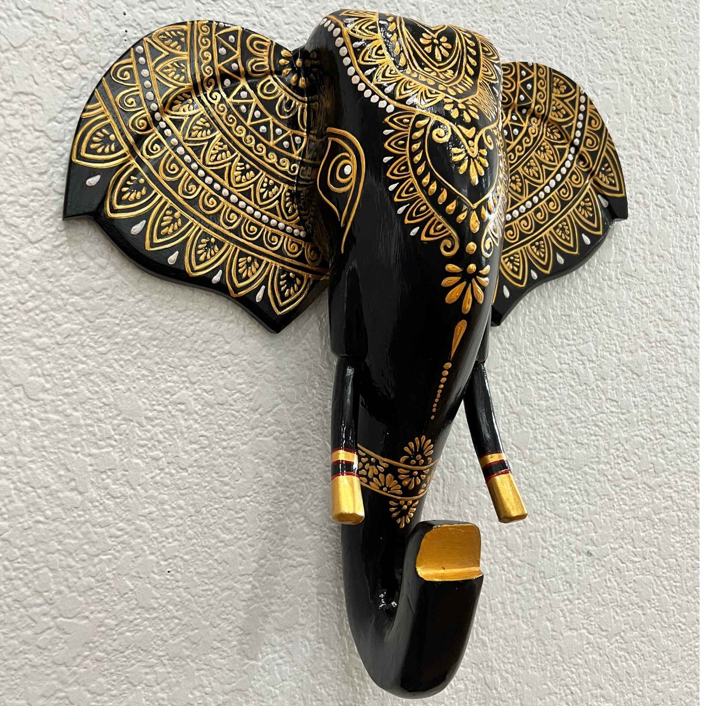 Hand-painted 17-inch wooden black and gold elephant head wall art with vibrant Indian-inspired designs