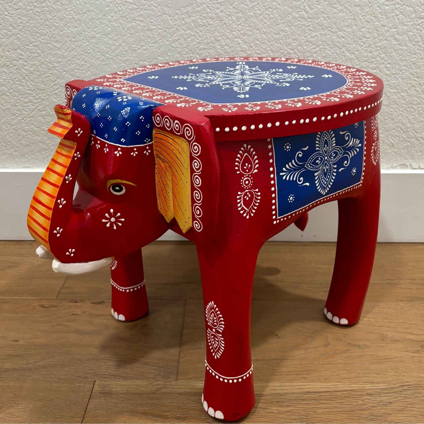 Side view of the red blue elephant stool showcasing sturdy construction