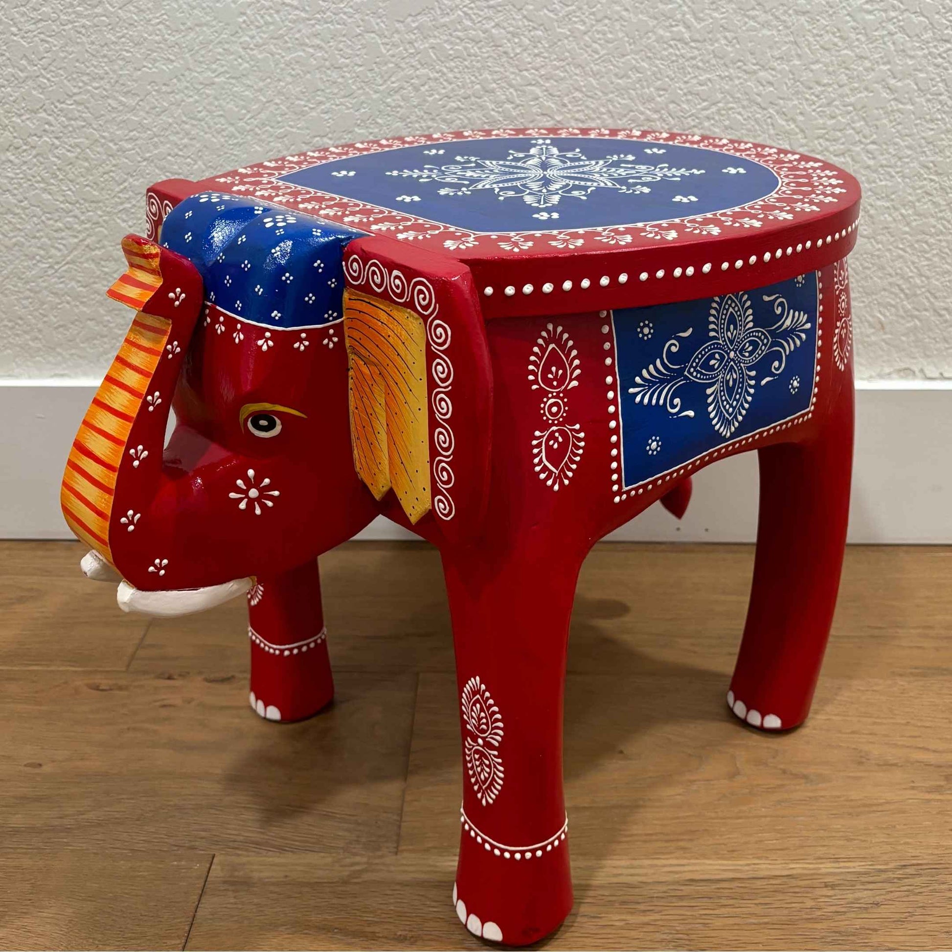 Side view of the red blue elephant stool showcasing sturdy construction