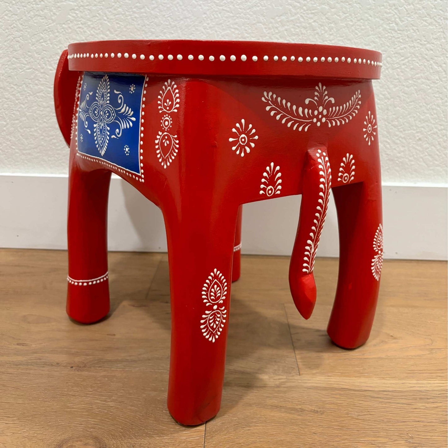 back view of the carved legs and textured black finish of the handcrafted elephant side table