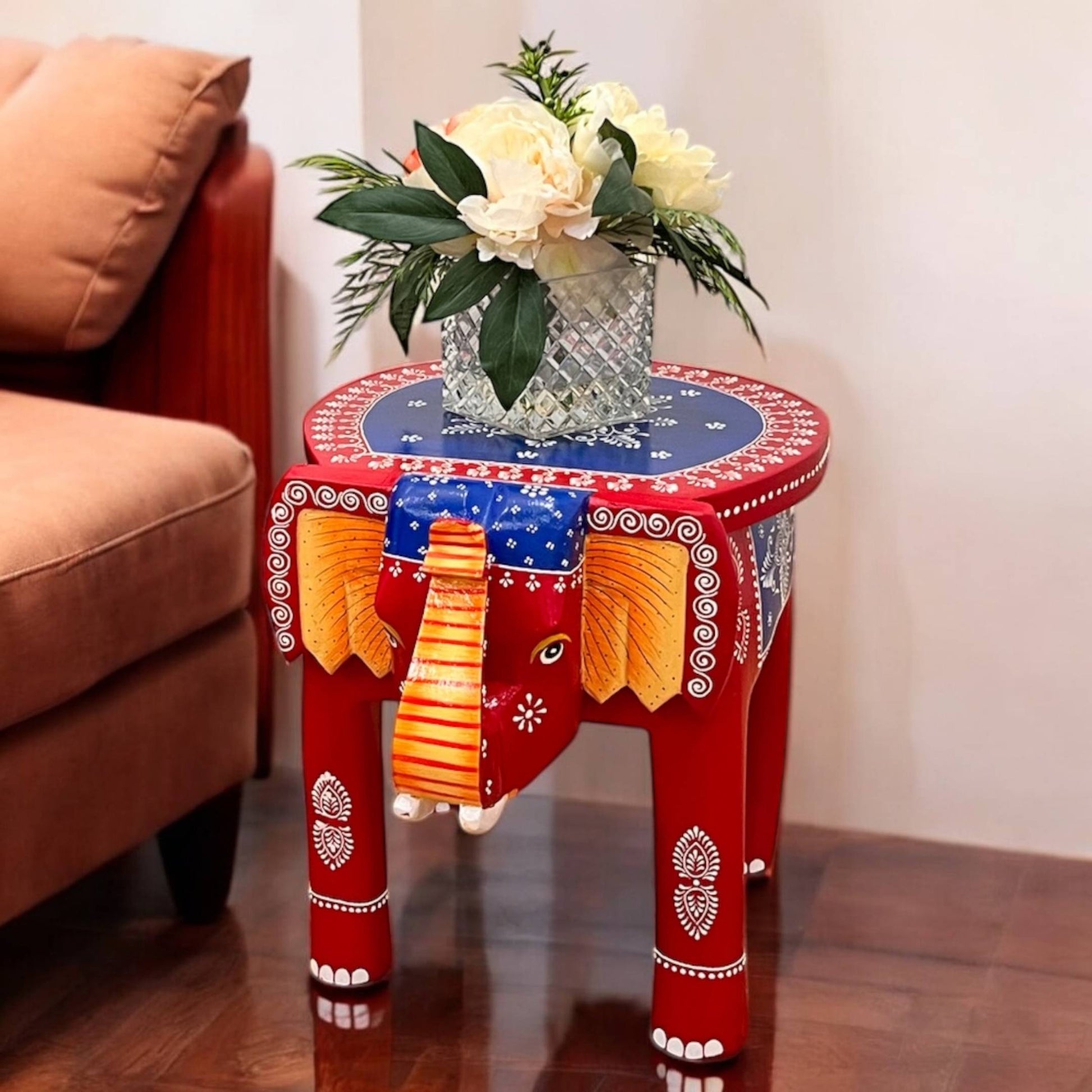 red blue elephant stool displayed as a stylish accent table in a modern living room setting