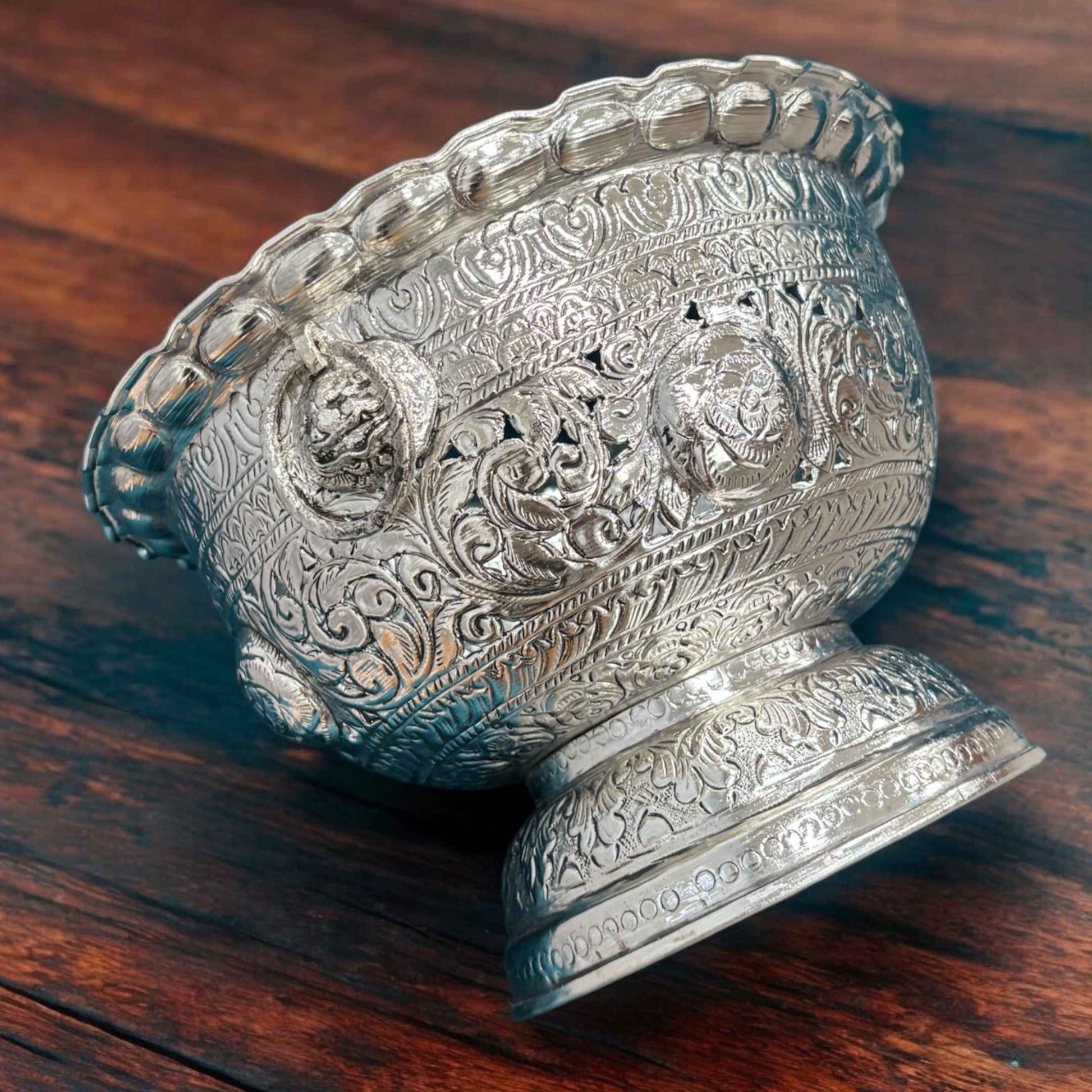 Close-up of the bowl's intricate detailing and silver-plated finish, emphasizing the artisanal quality and texture of the brass material