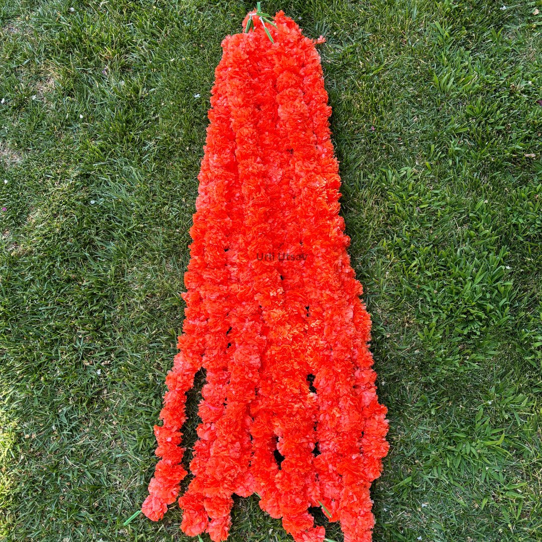 A set of ten orange artificial marigold garlands from Urli Utsav Decor, priced approx $2 per string