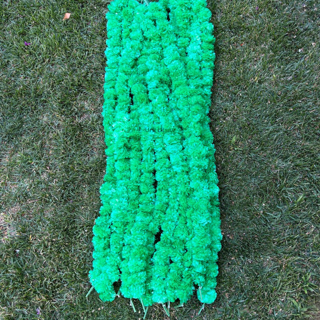 A set of ten green artificial marigold garlands from Urli Utsav Decor, priced approx $2 per string