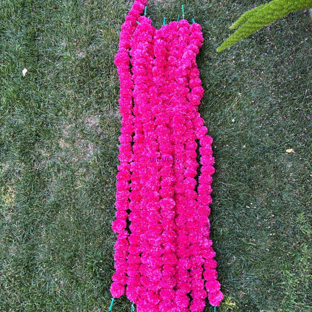 A set of ten pink artificial marigold garlands from Urli Utsav Decor, priced approx $2 per string