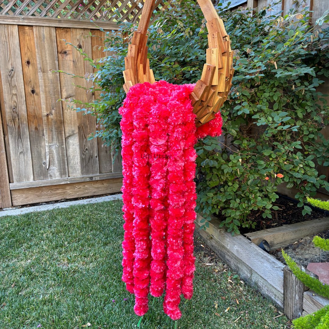 A set of ten red artificial marigold garlands from Urli Utsav Decor, priced approx $2 per string