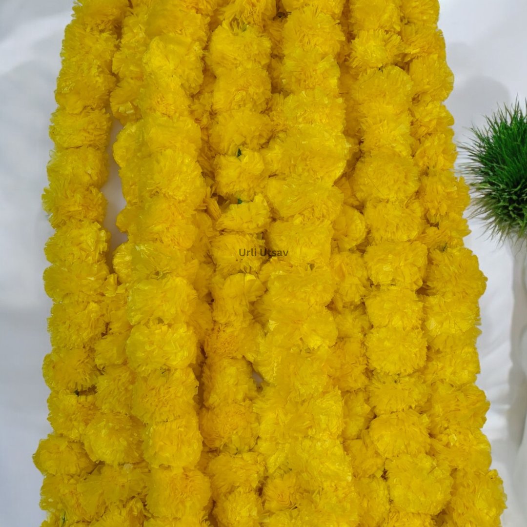 A set of ten yellow artificial marigold garlands from Urli Utsav Decor, priced approx $2 per string