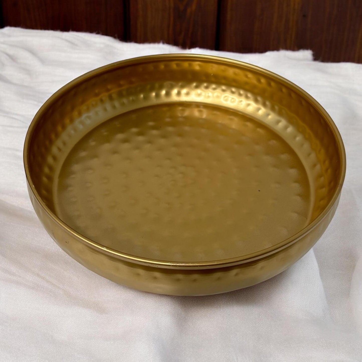 Traditional Indian urli bowl featuring a luxurious gold finish, ideal for home accents
