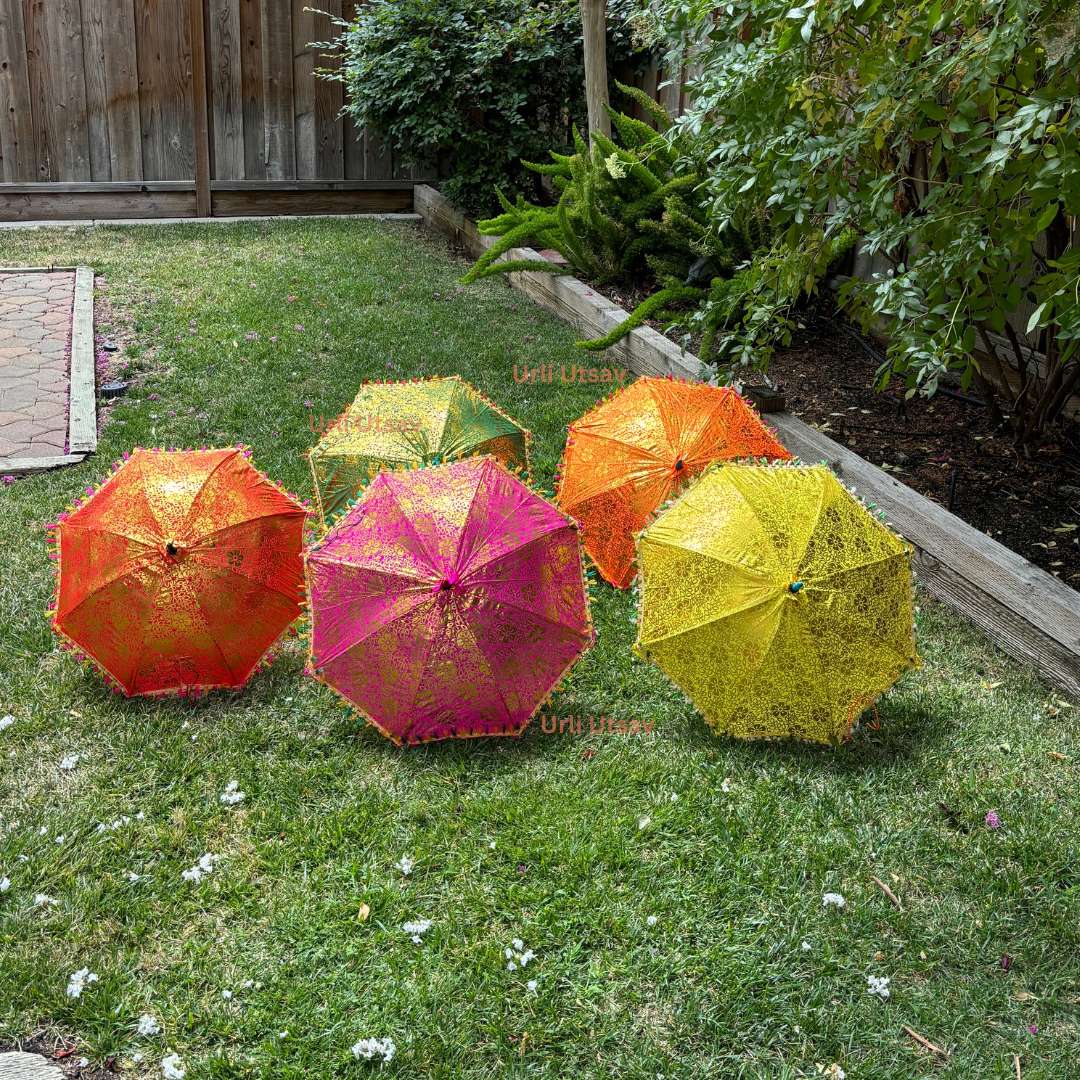 Assorted bulk umbrellas made of silk with golden prints, perfect for large-scale event decor