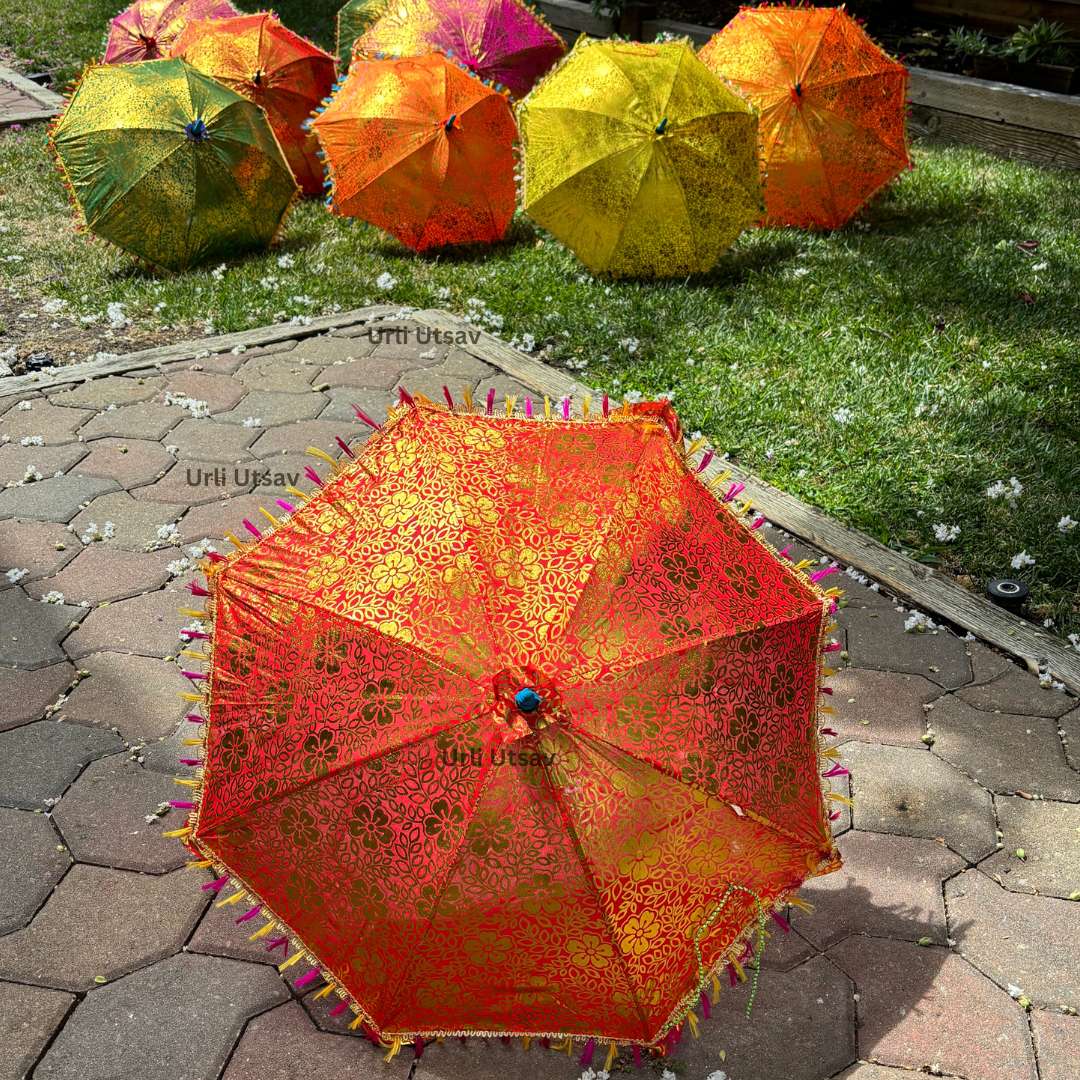 Rajasthani silk umbrella showcasing vibrant colors and golden motifs, suitable for festive decorations Assorted silk umbrellas with traditional golden prints, available in bulk for large gatherings