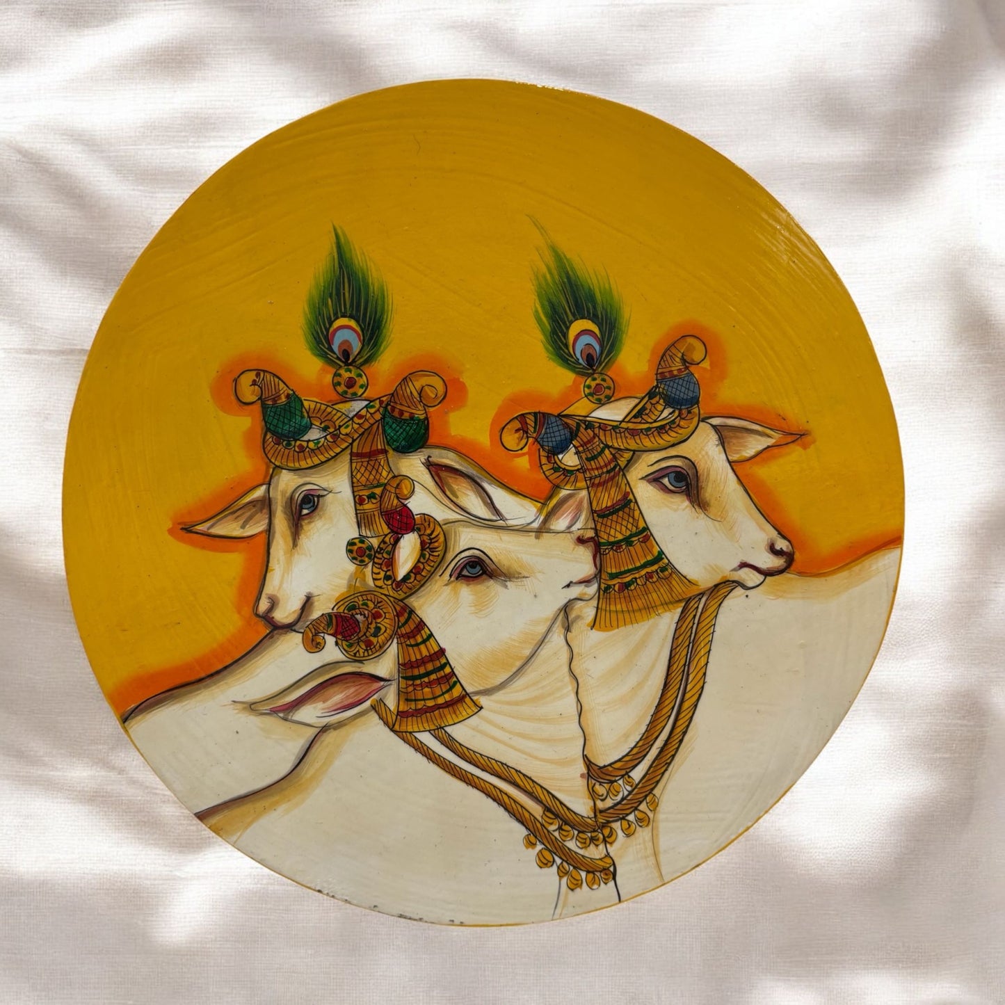 Handpainted Yellow Pichwai Cow wall plate featuring intricate traditional Indian art with vibrant colors, depicting the divine couple in a bohemian style