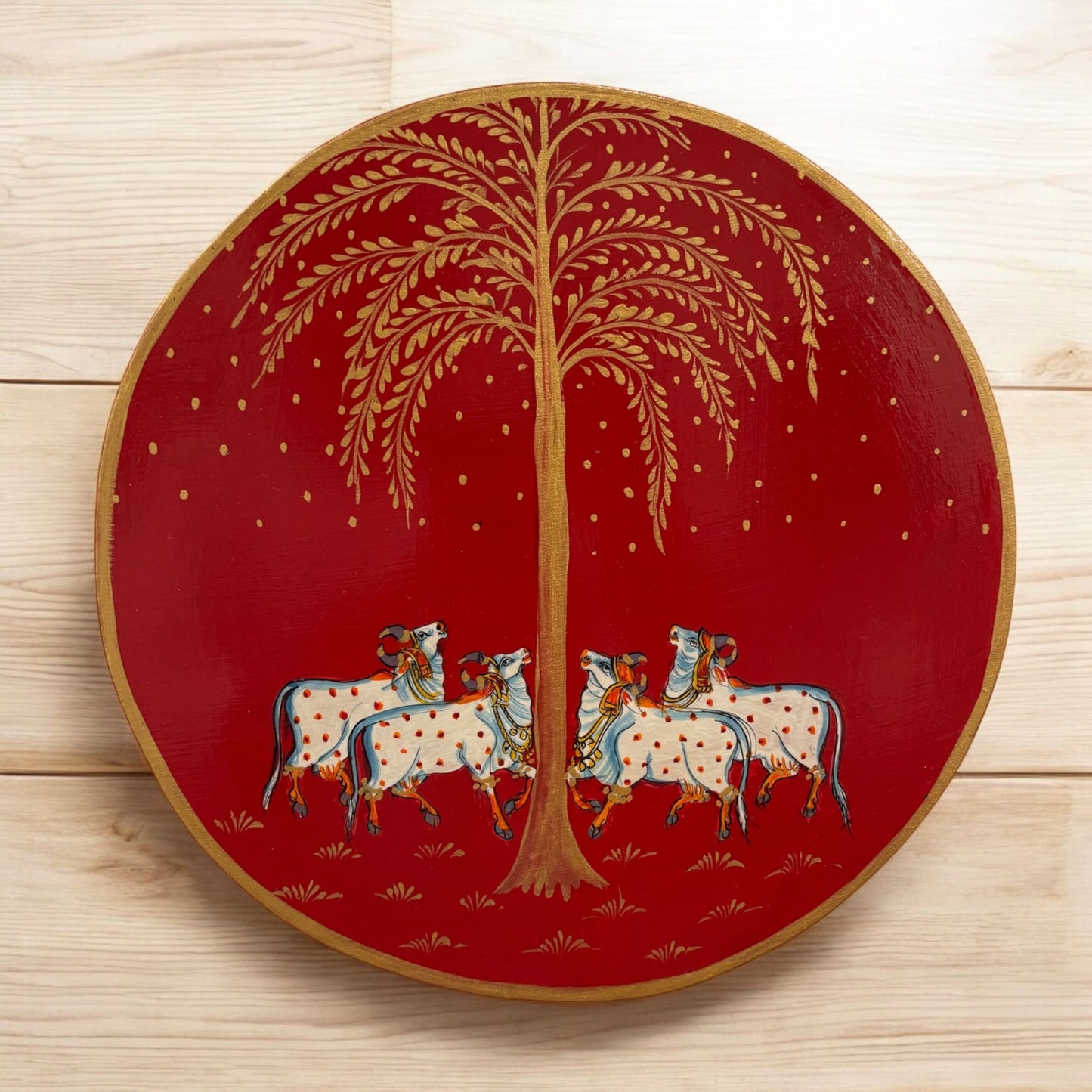 Handpainted Red Kamdhenu Cow wall plate featuring intricate traditional Indian art with vibrant colors, depicting the divine couple in a bohemian style