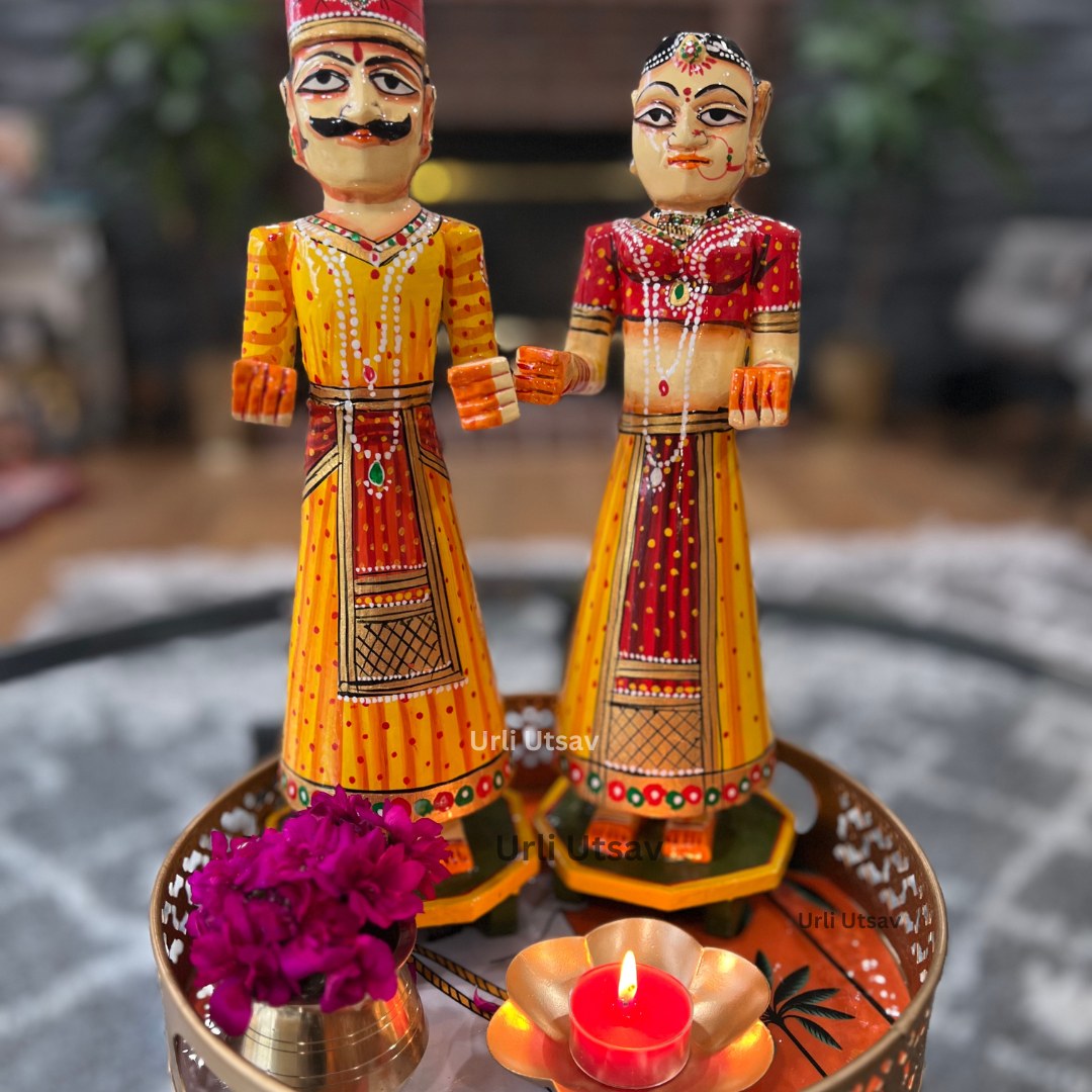Close‑up of orange cow-print tray on a table, accessorized with decorative figurines and small flowers, showcasing festive table styling.