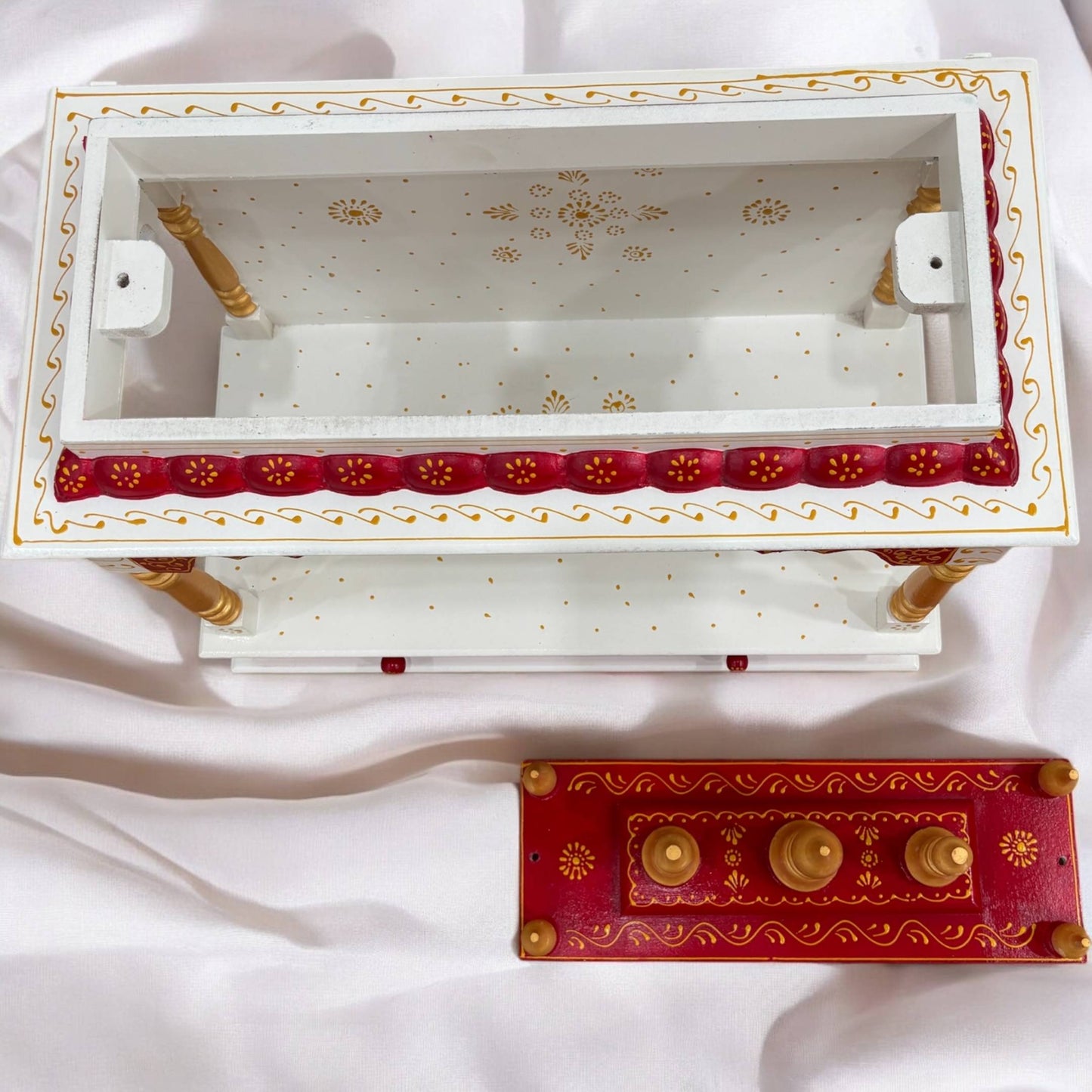 Handcrafted wooden mandir in vibrant red with golden accents