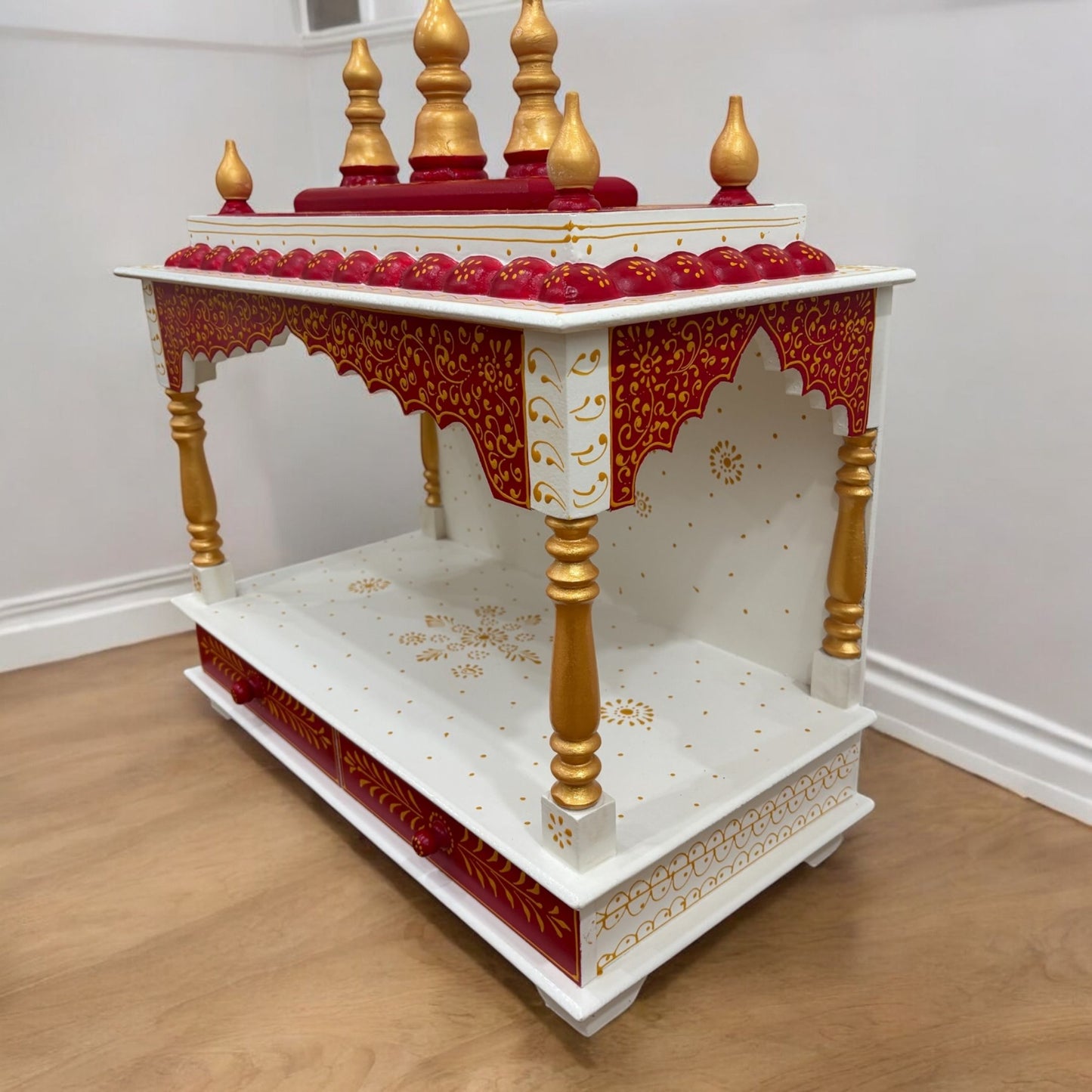 Compact and elegant pooja mandir made of durable wood in a rich red finish