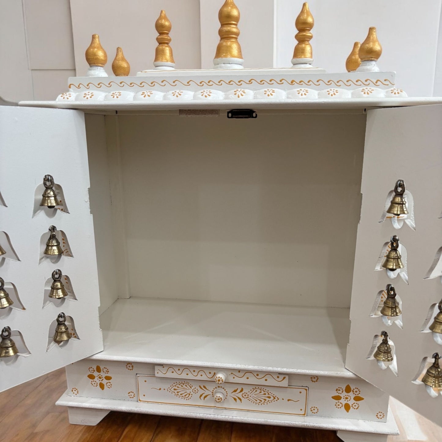 White Temple with Brass Bells & Doors - Interior view of the white and gold temple with ample space for idols and decorative items