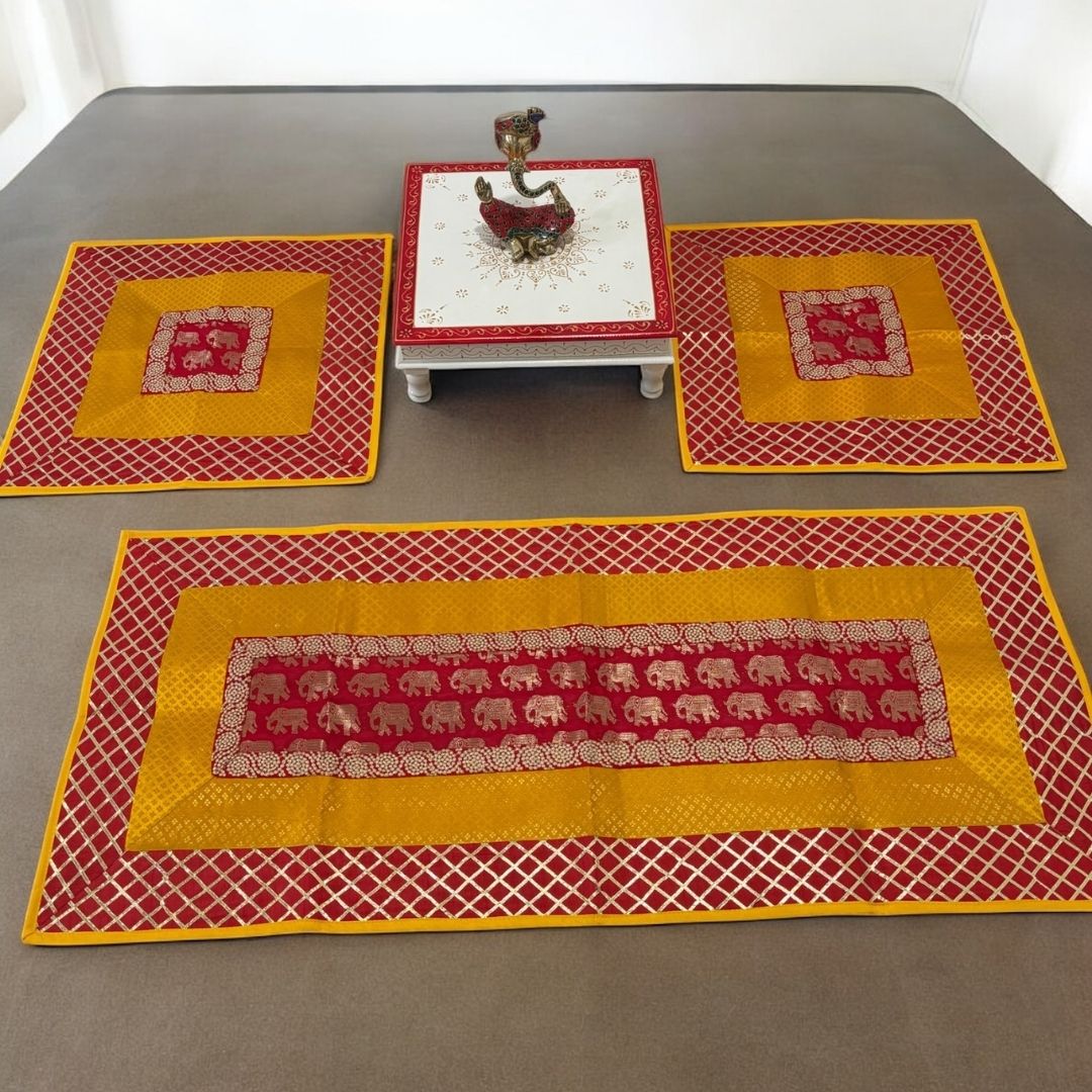 Set of red and yellow patterned table mats on a gray surface