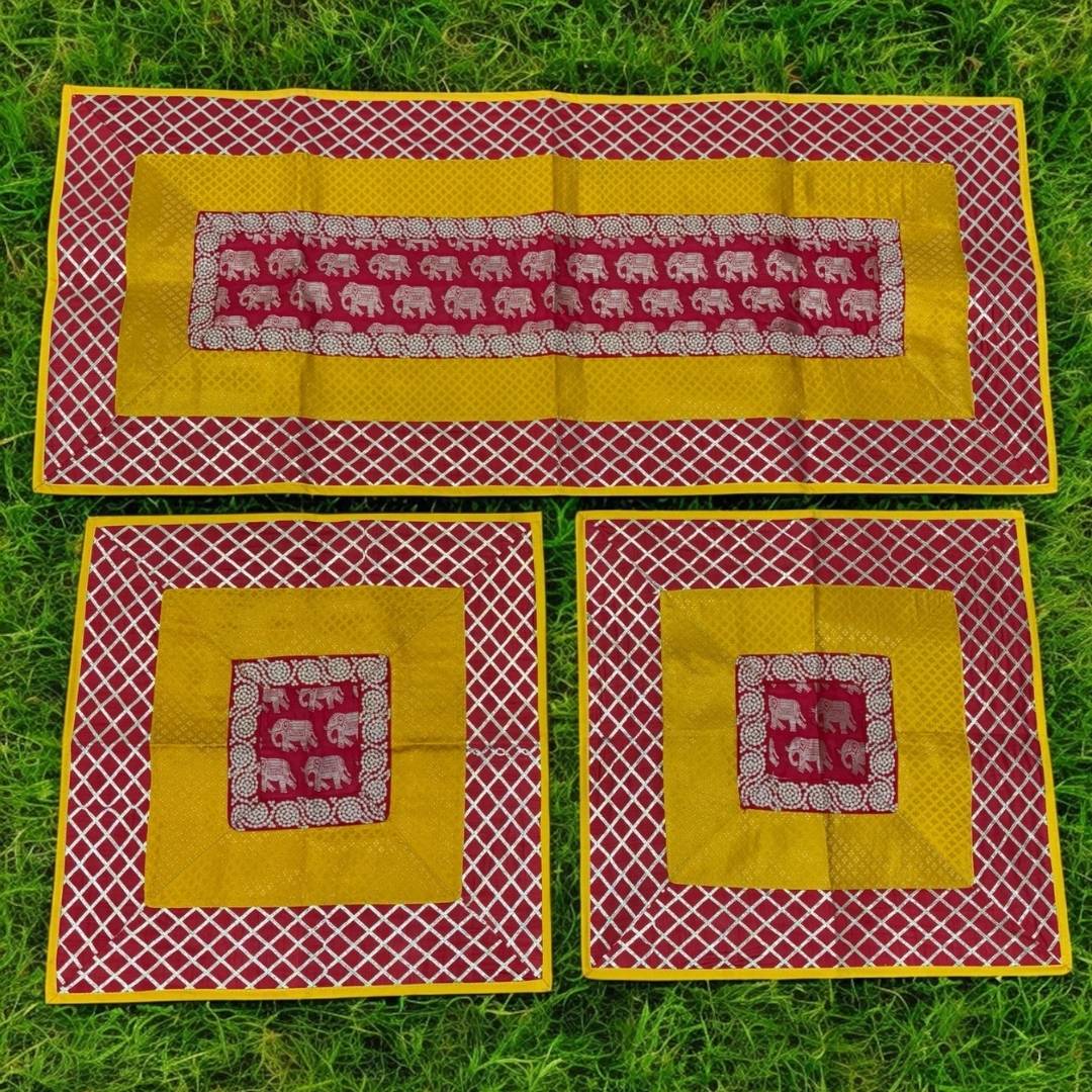 Set of three fabric placemats with elephant pattern on a grass background