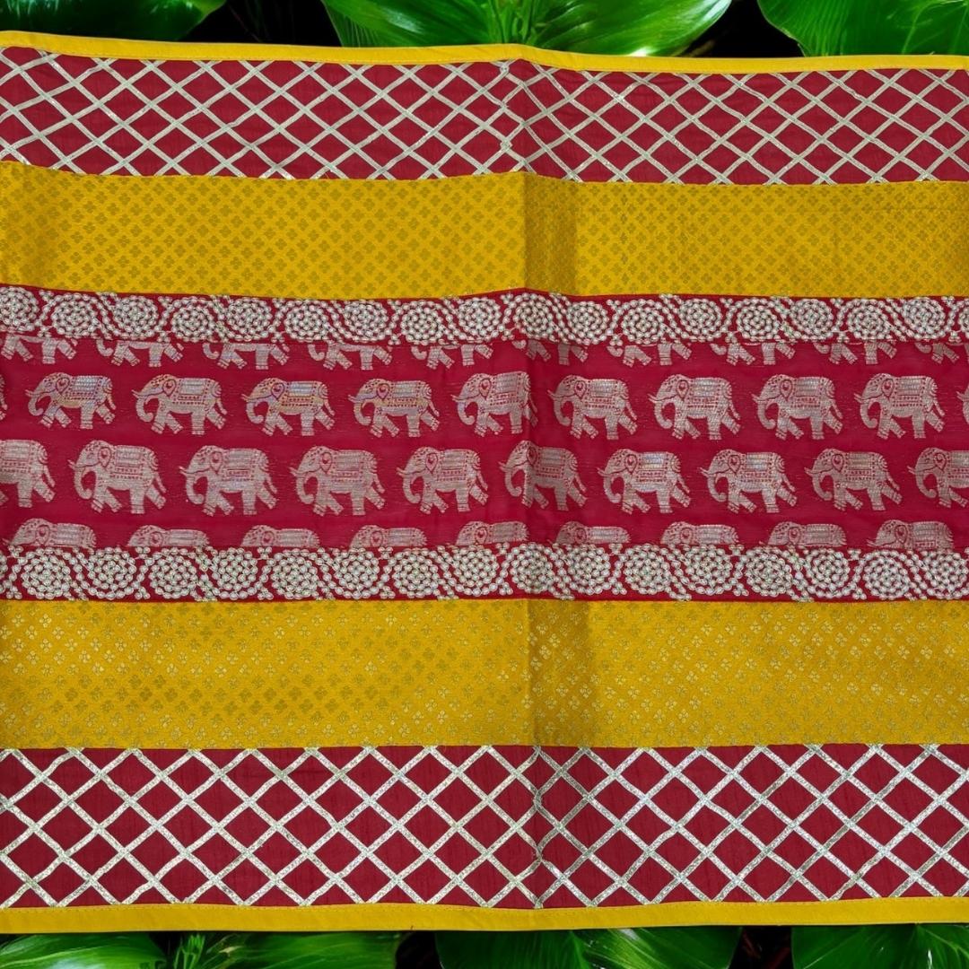Close-up of silk brocade fabric showing intricate elephant motif and vivid red-yellow color—prayer mat & ethnic runner.
