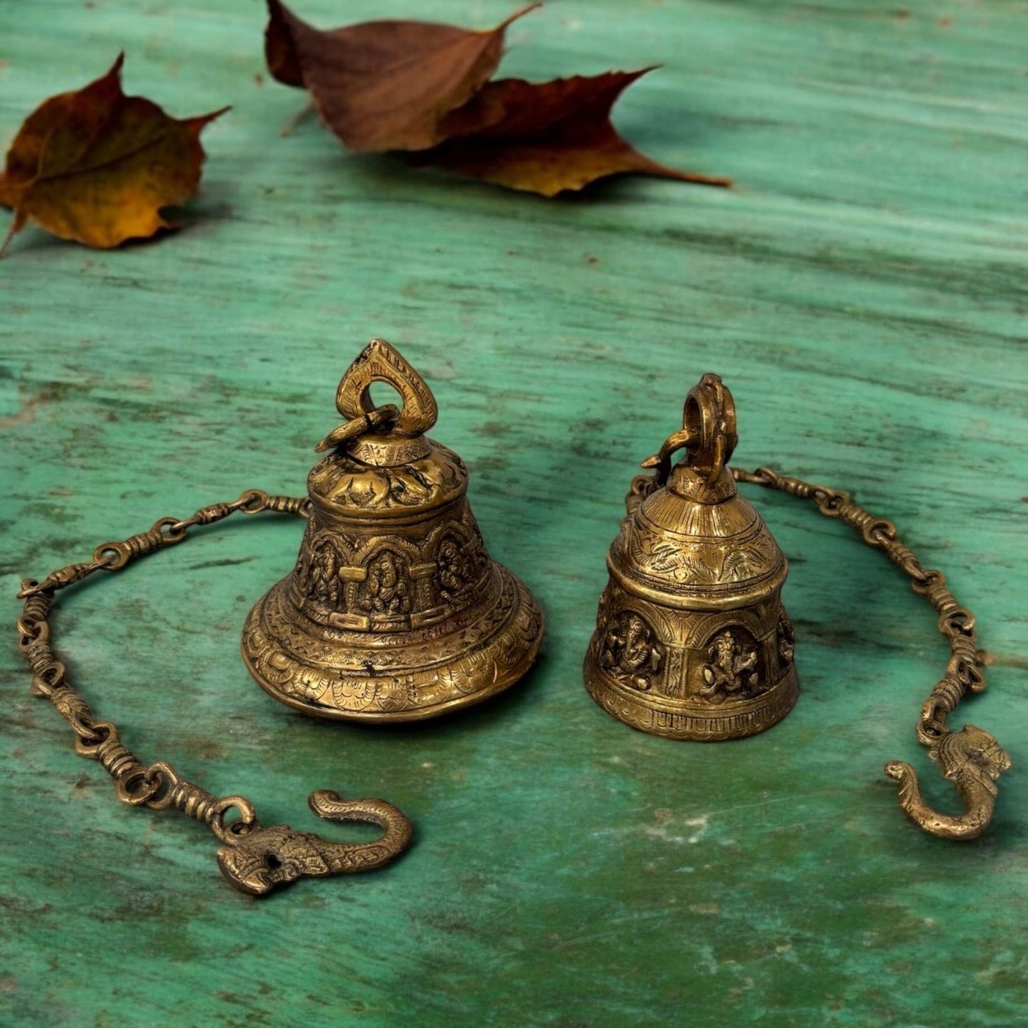 A handcrafted 33-inch brass hanging bell with intricate engravings, suspended by a sturdy chain, ideal for temple or home entrance decor