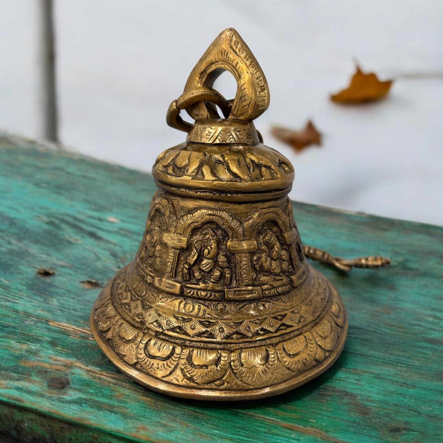 Detailed image showcasing the fine engravings of ganesha on the brass bell, highlighting traditional Indian craftsmanship