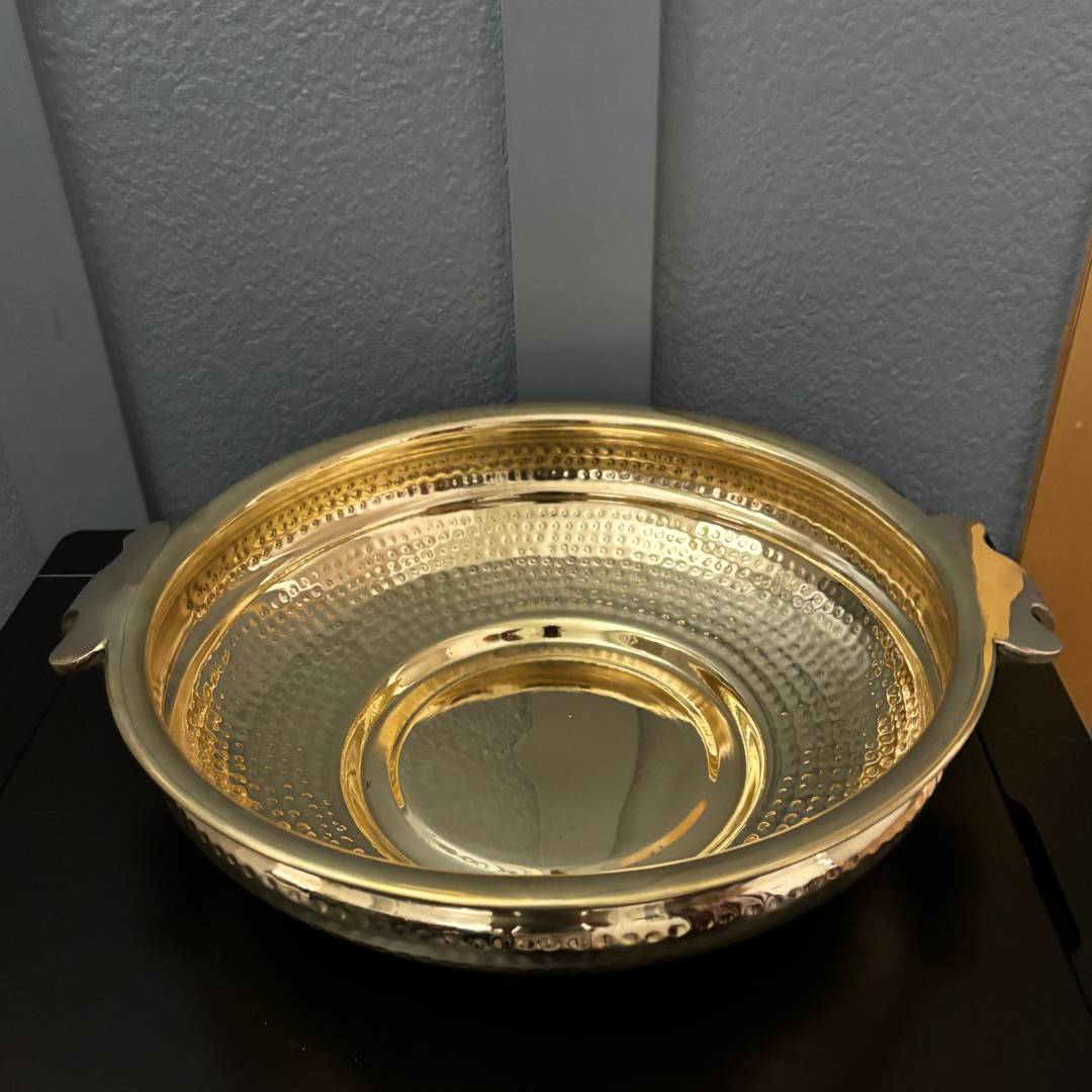Top view of elegant brass hammered urli—traditional Indian decor piece suitable as a centerpiece for festive occasions