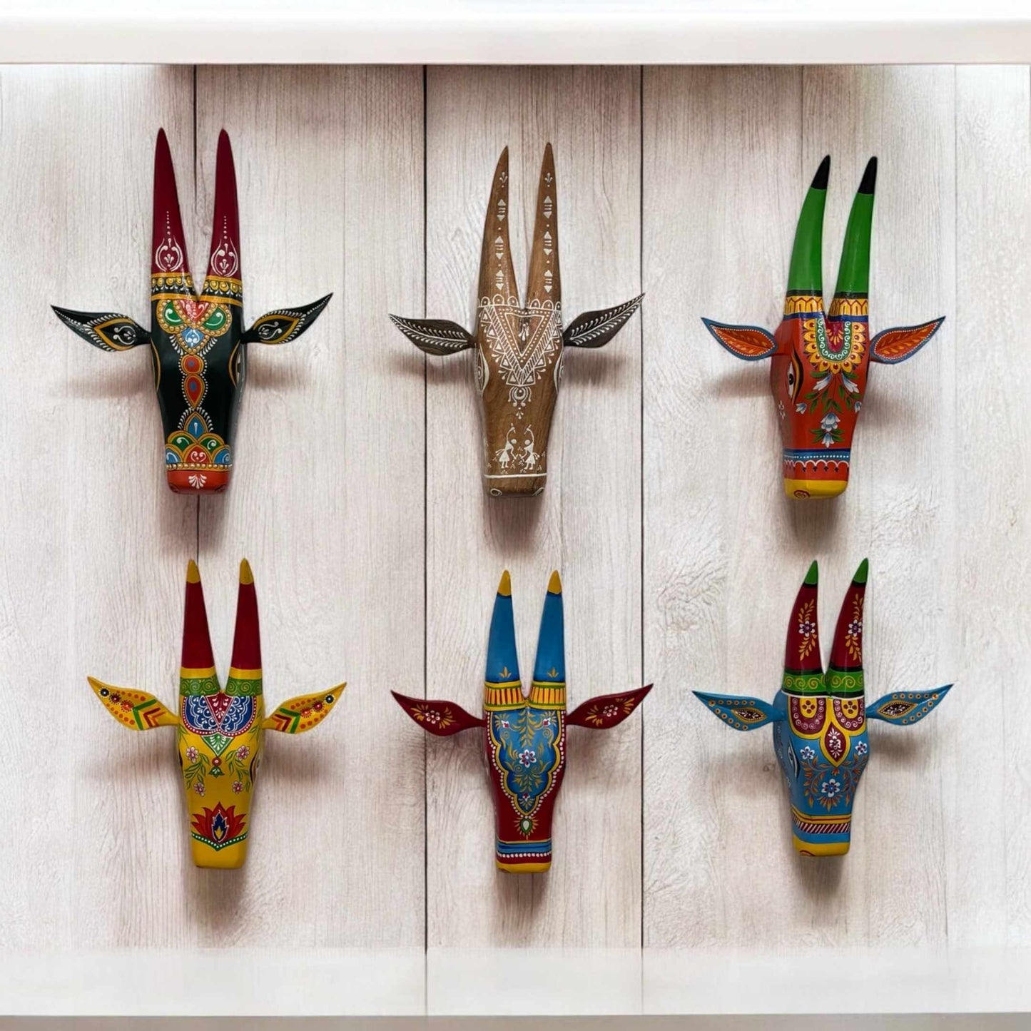 Hand-painted wooden Nandi cow head wall art by Urli Utsav, showcasing intricate ethnic designs in vibrant colors