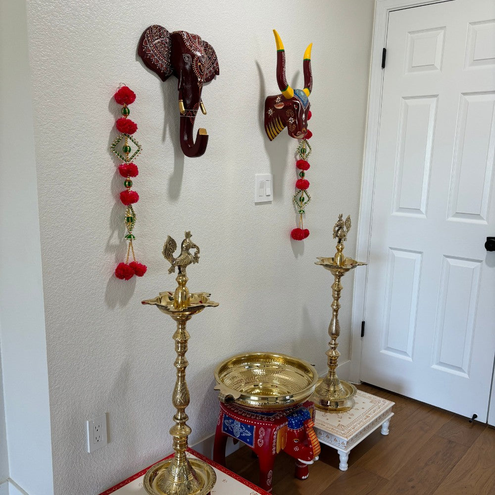 The wooden elephant head displayed on a living room wall as a statement decor piece