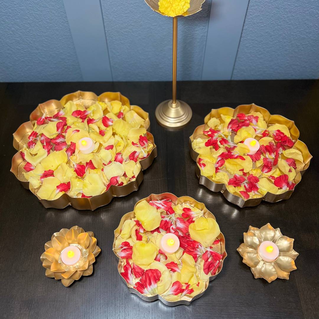 Decorative setup featuring the lotus urli bowls filled with water and floating candles, placed on a festive table.
