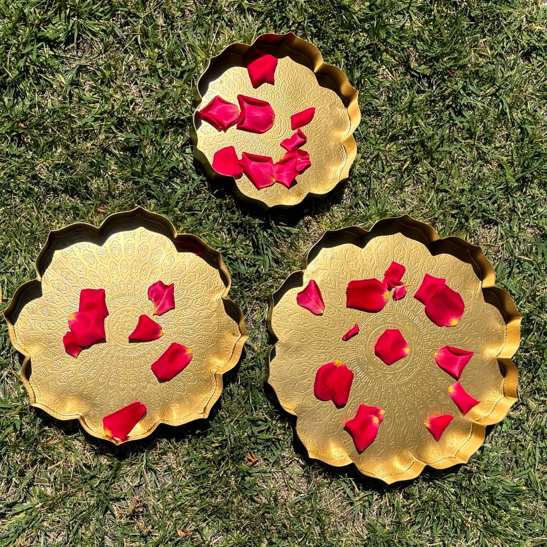 Decorative setup featuring the lotus urli bowls filled with water and floating candles, placed on a festive table.