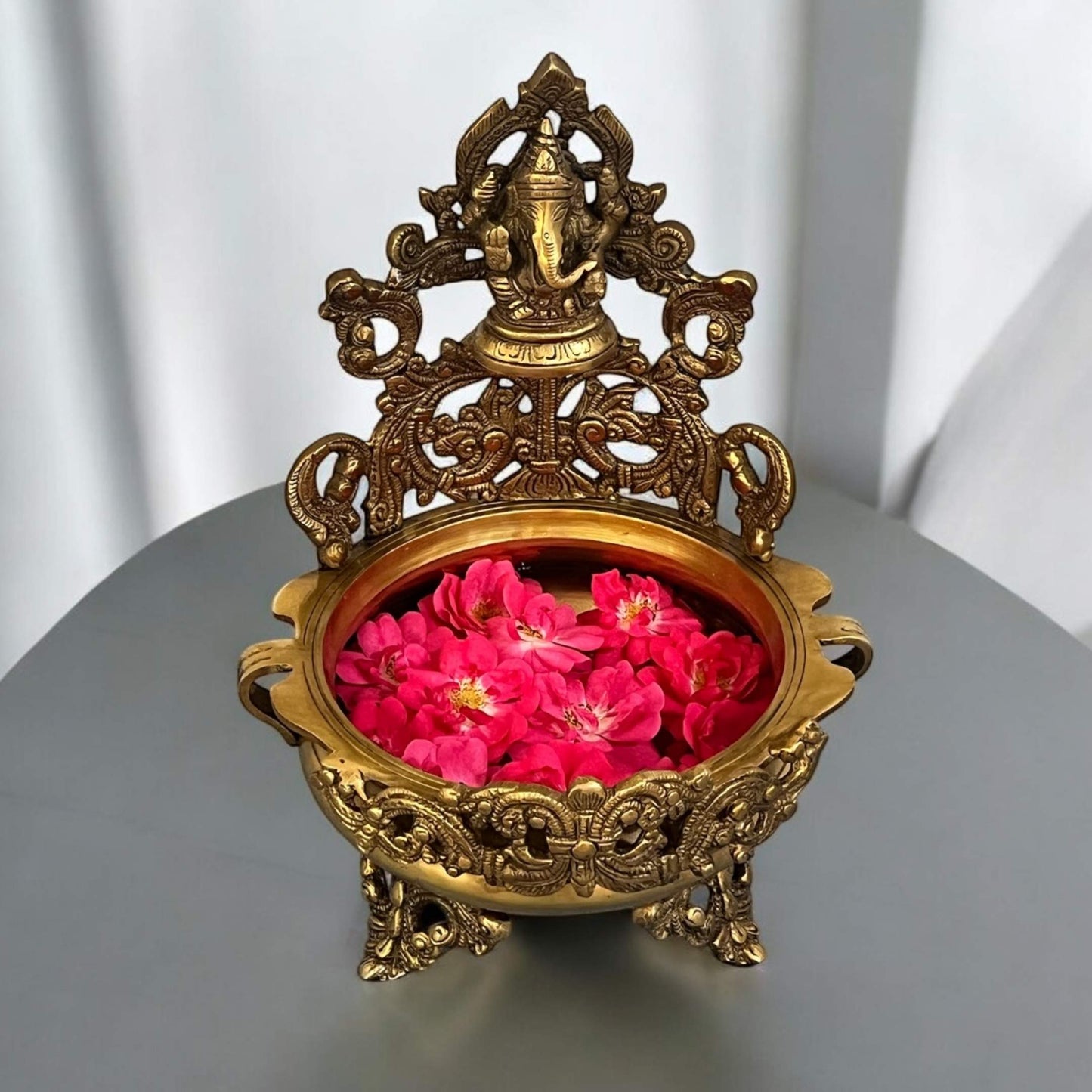Premium Brass Ganesha Urli Bowl featuring a finely engraved brass Ganesha idol; a handcrafted decorative vessel ideal for floating flowers and candles, perfect for urli utsav decor and traditional Indian home temple settings