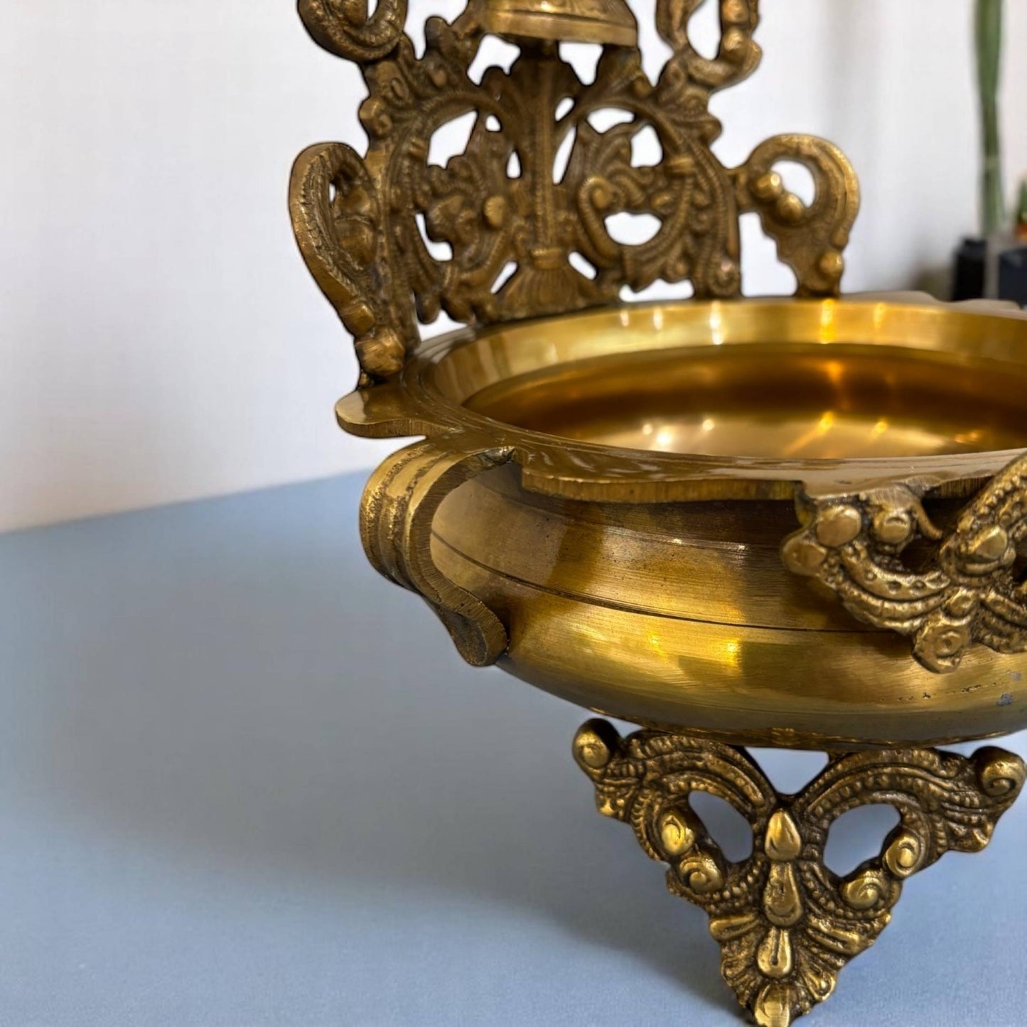 Side angle of the Elegant Brass Ganesha Urli, highlighting the bowl's ornate engravings and the serene expression of the brass Ganesha idol; a quintessential piece for urli utsav decor and traditional Indian celebrations