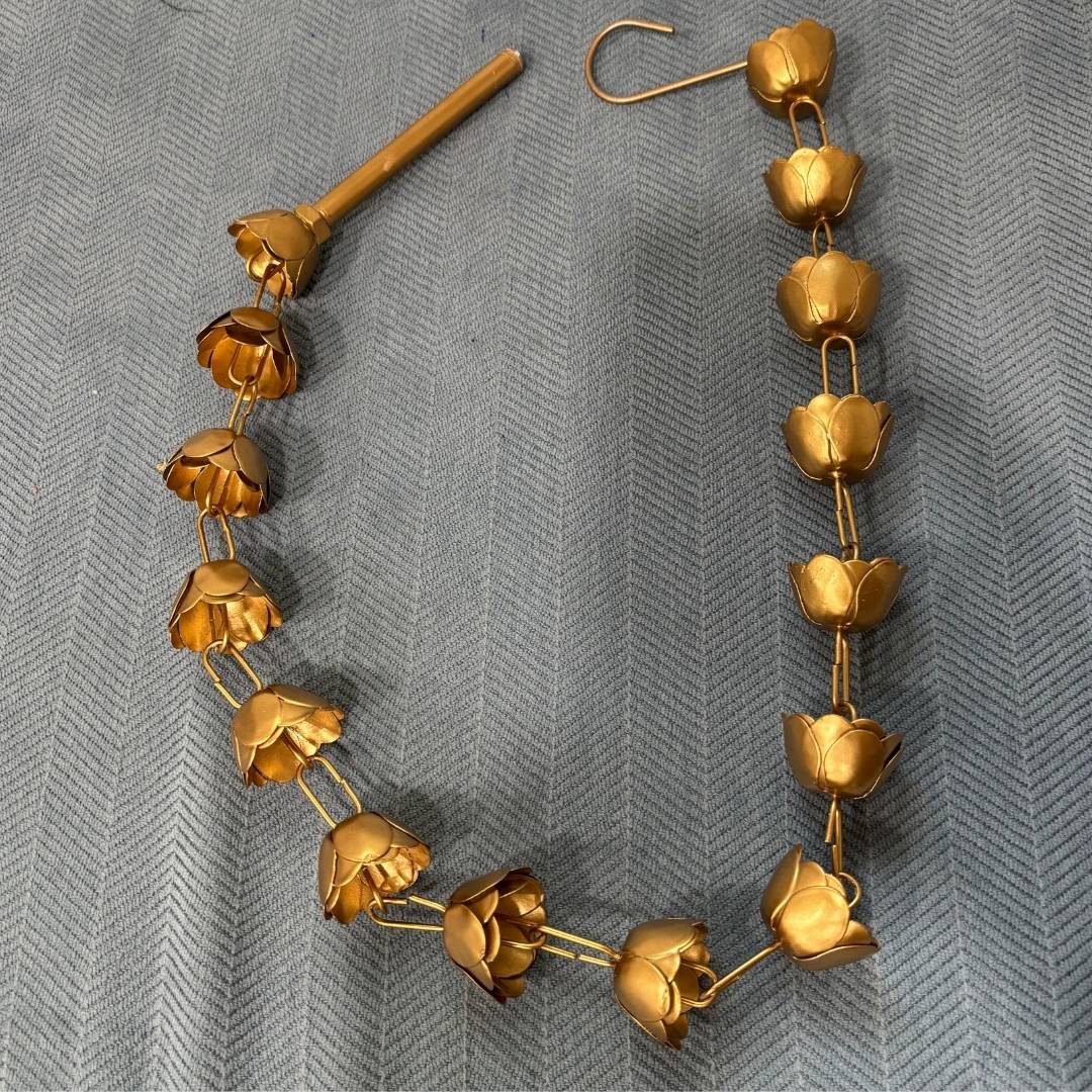 Close up look of Gold floral chain used for hanging the urli.