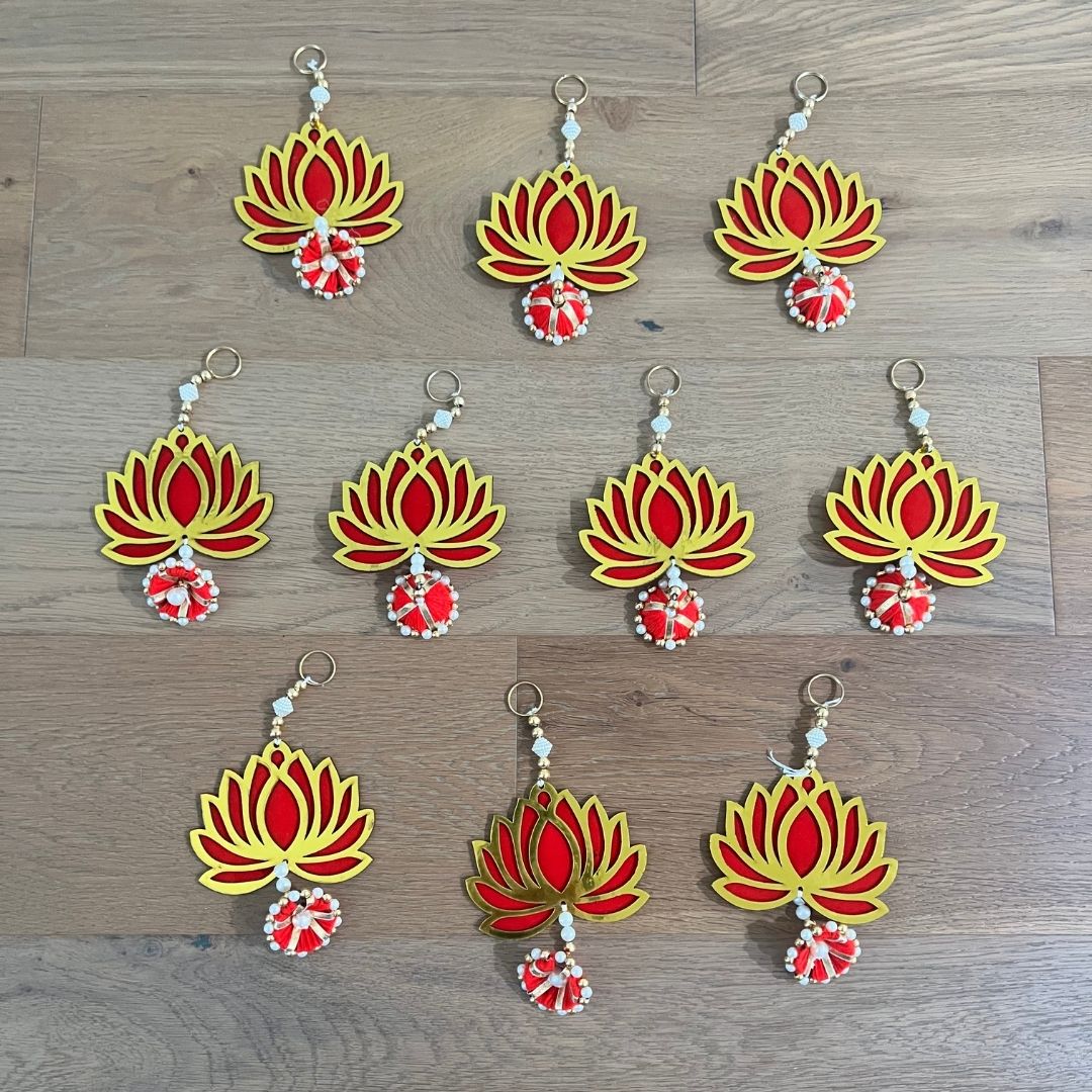 Red and yellow lotus flower-shaped dangler on a wooden surface