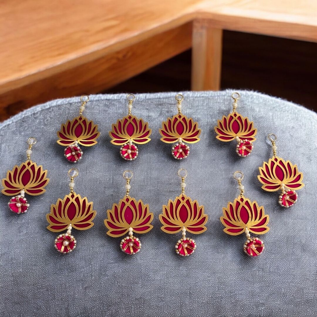 Red and gold lotus-shaped garland on a gray surface with a wooden background