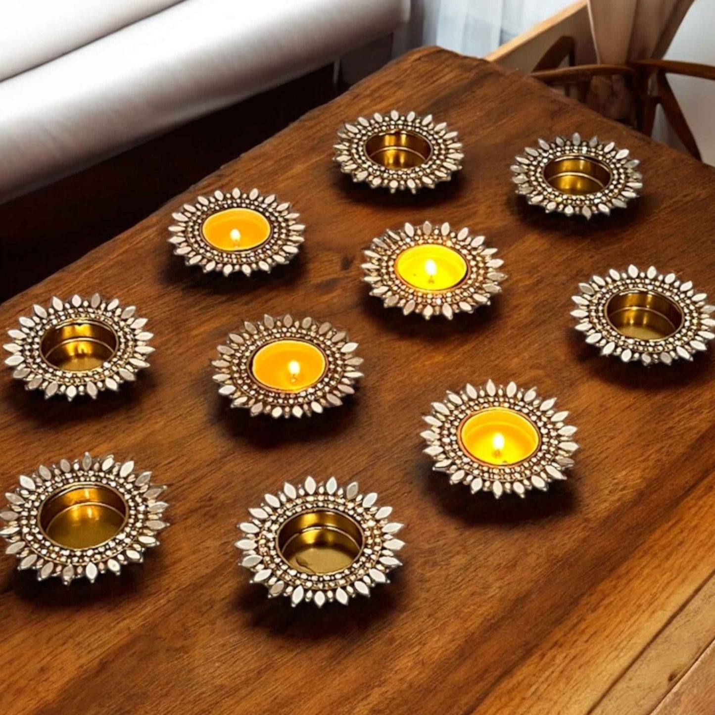 Sunflower gold mirror decorative candle holders with candles on a wooden surface