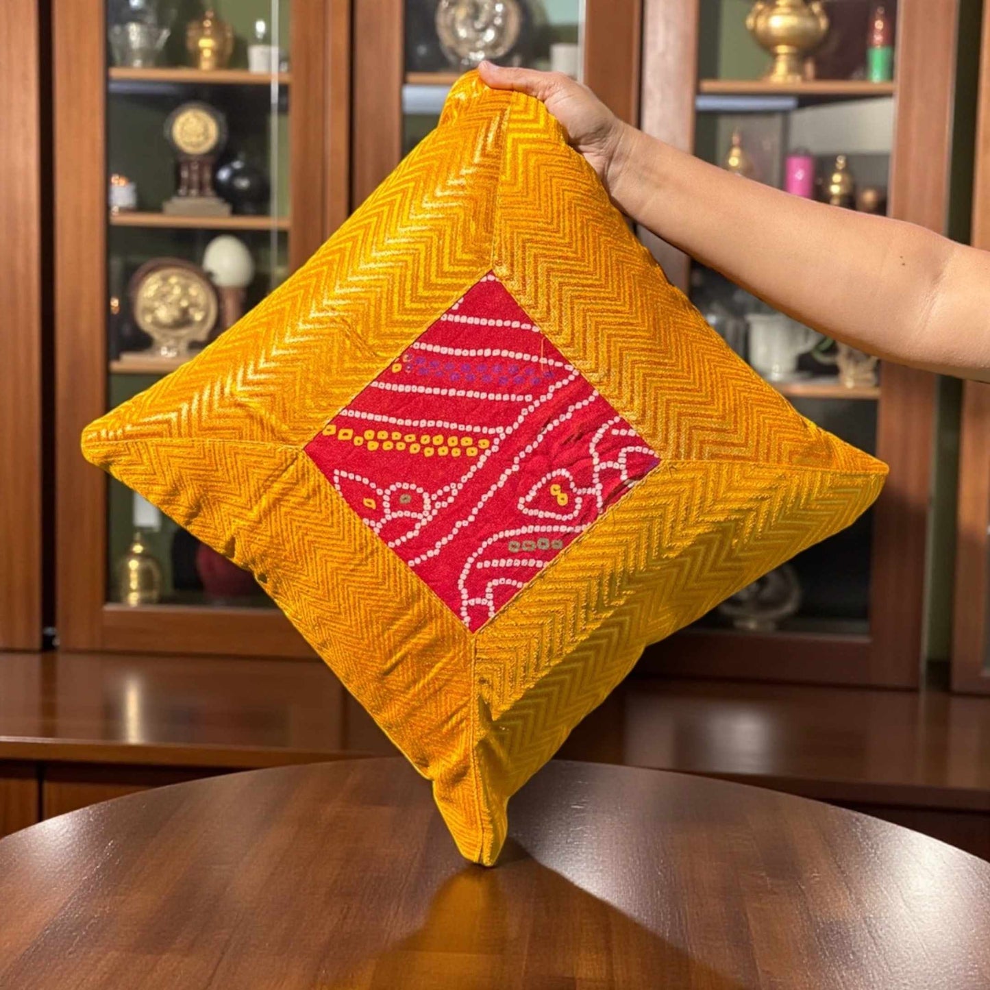 Close-up of yellow 16×16 Bandhani silk brocade cushion cover showing Bandhani motif and texture.