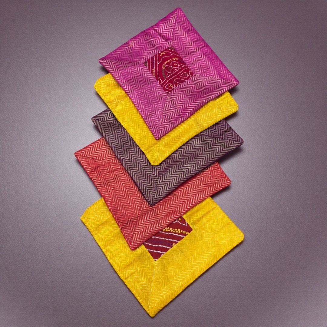 Stack of five 16×16 Bandhani silk brocade cushion covers (brown, yellow, red, pink, gold) — set of 5.