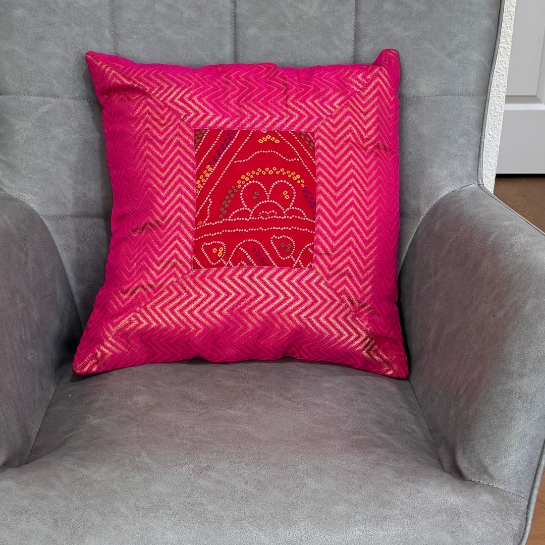 Pink 16×16 Bandhani silk brocade cushion cover on chair — vibrant Diwali decor idea