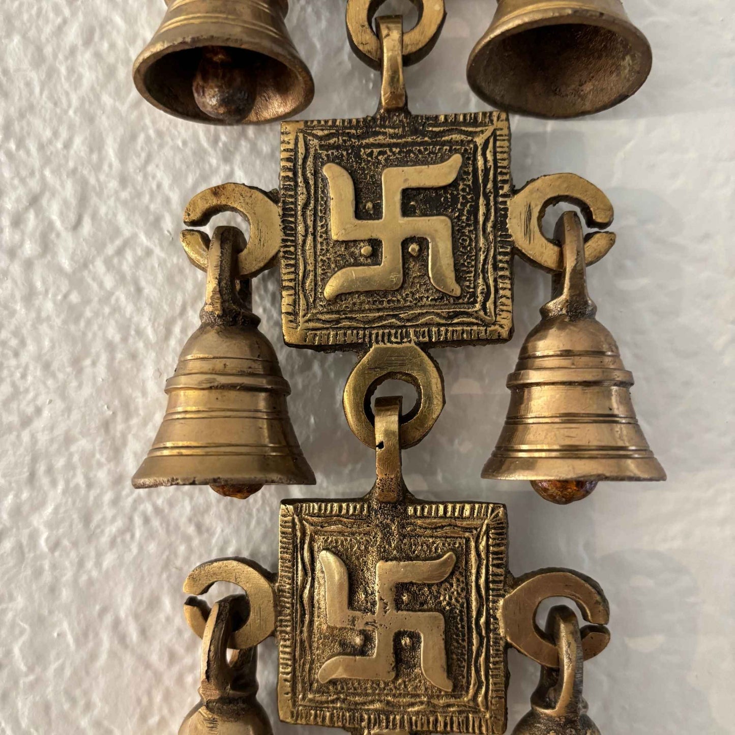 Detailed view highlighting the fine craftsmanship of the Swastik symbol, showcasing traditional Indian artistry in polished brass